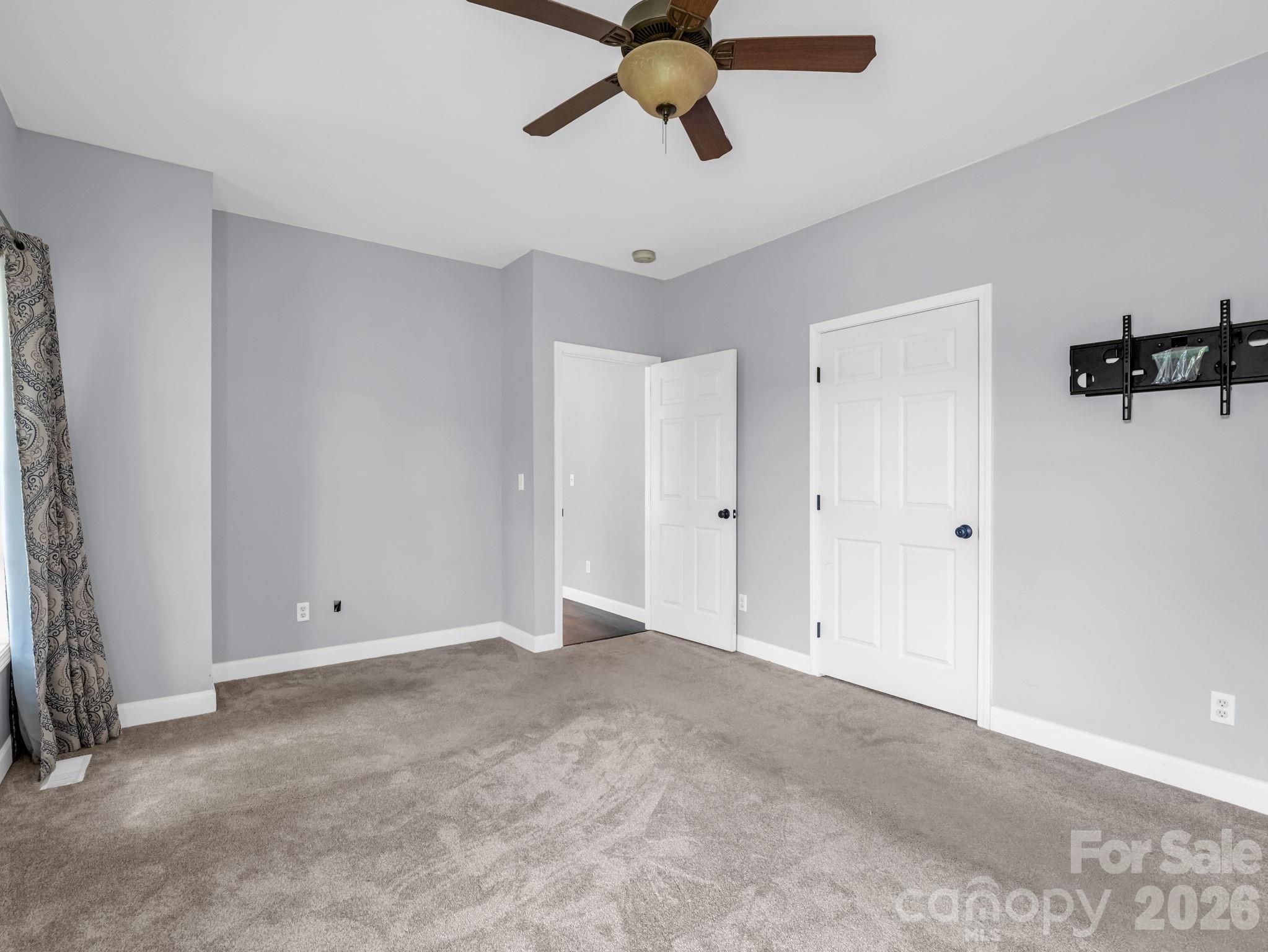 Primary bedroom with spacious walk-in closet. - 355 Hidden Meadow Drive, Hendersonville