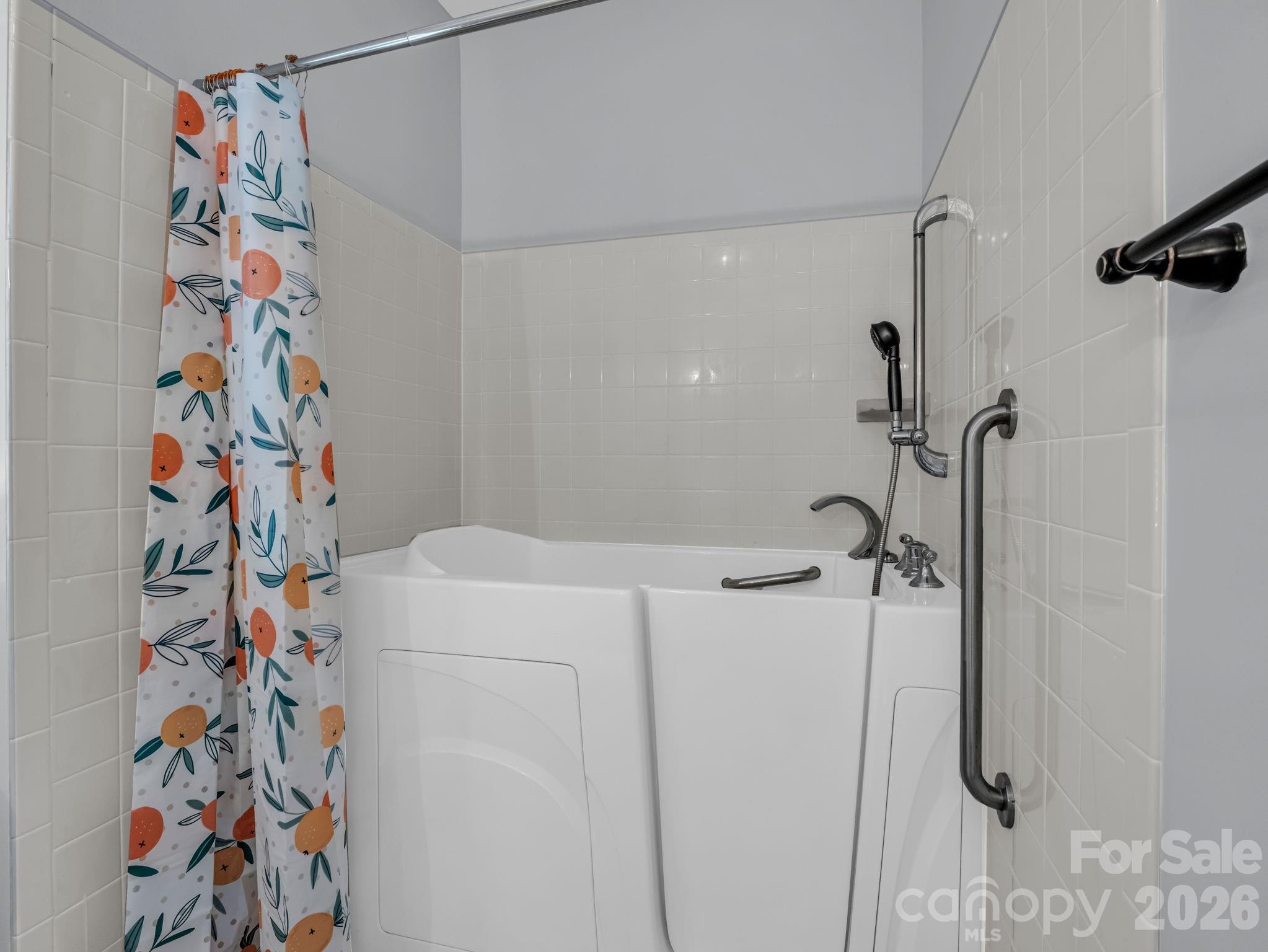 This accessible walk-in tub functions as a normal shower (current owners never used the bathtub function). - 355 Hidden Meadow Drive, Hendersonville