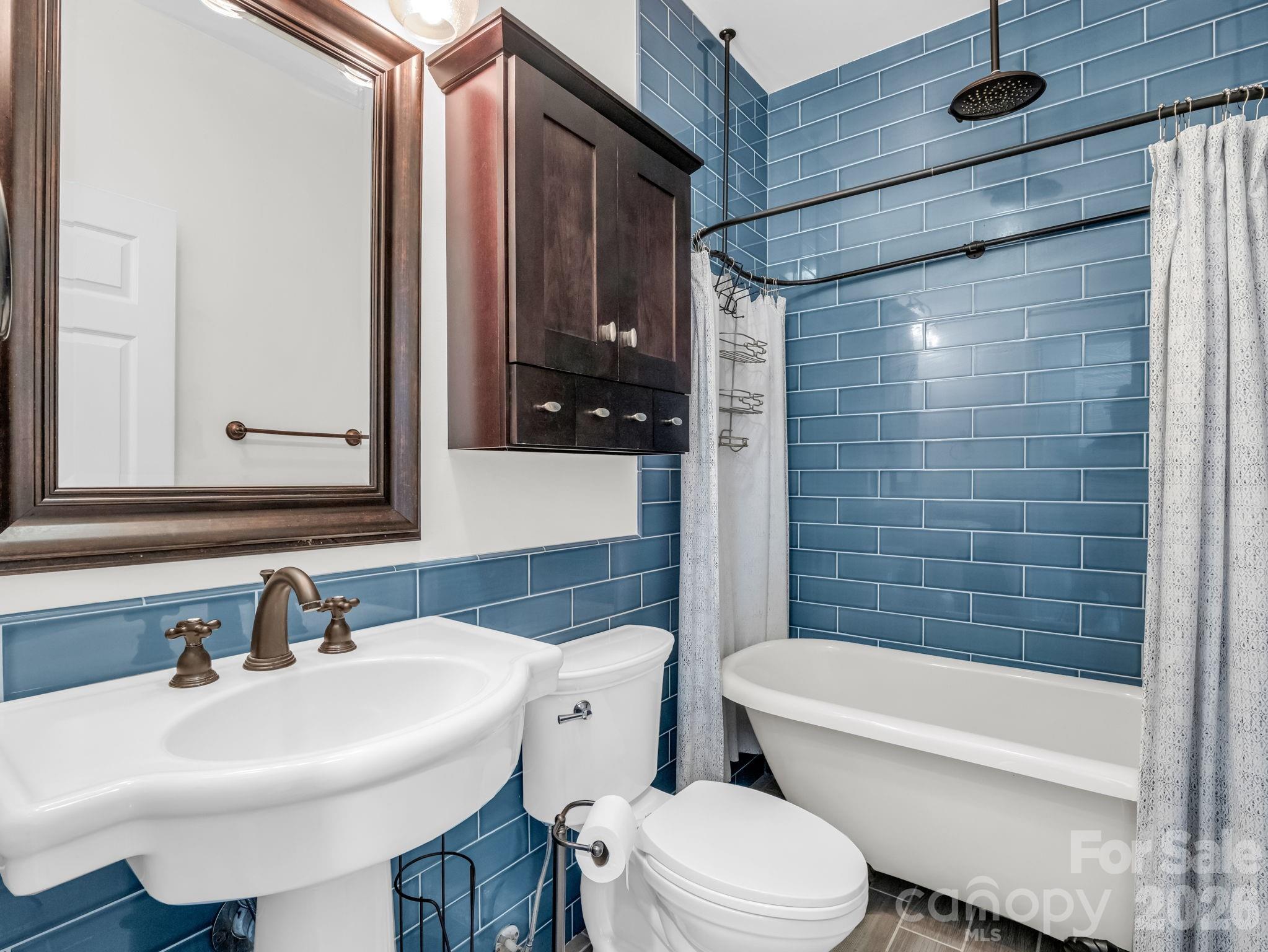 Beautifully updated guest bathroom with charming clawfoot tub / shower combo. - 355 Hidden Meadow Drive, Hendersonville