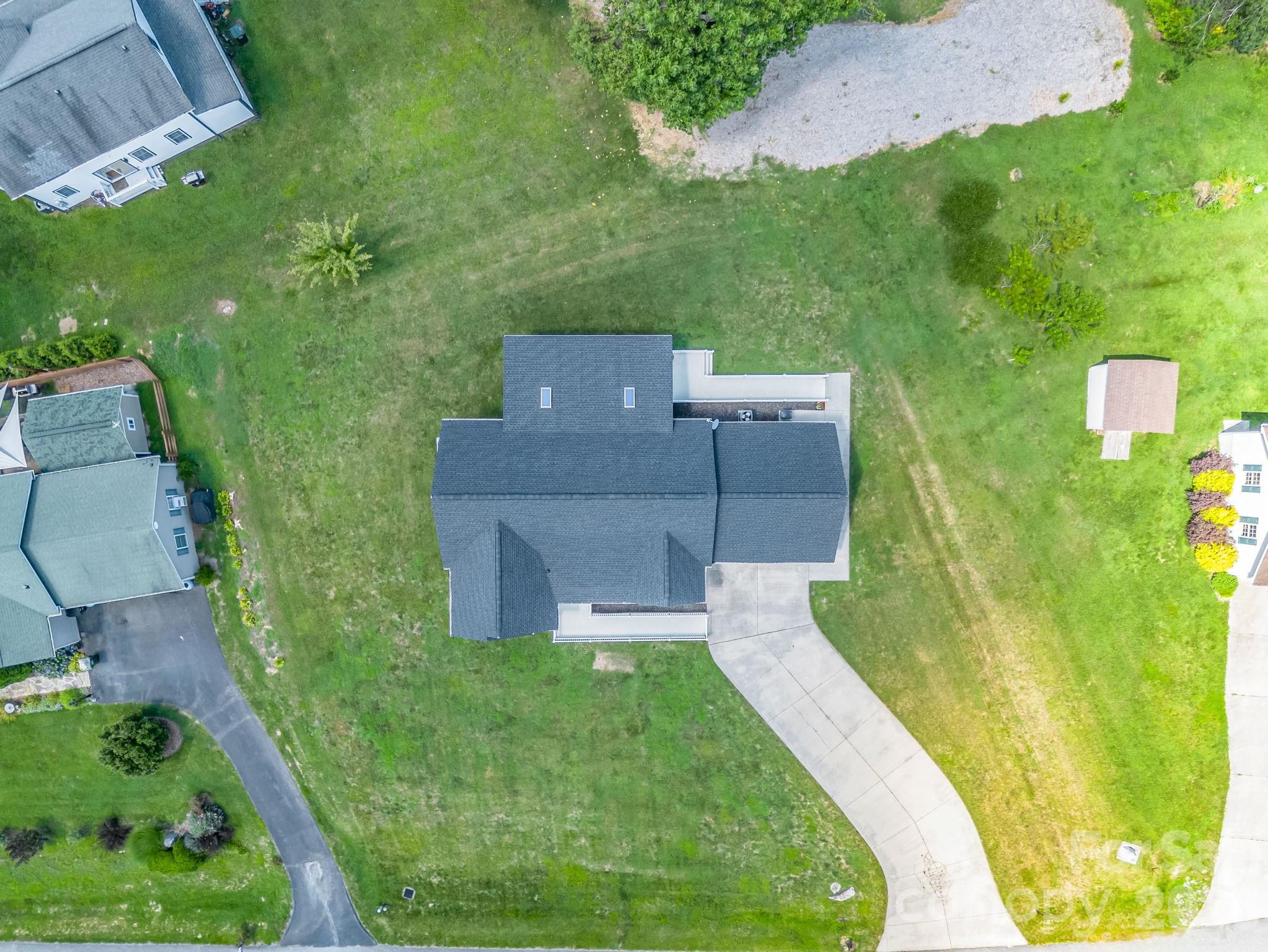 Aerial view of home and 0.45 acres lot. Brand new roof was installed in November 2025. - 355 Hidden Meadow Drive, Hendersonville