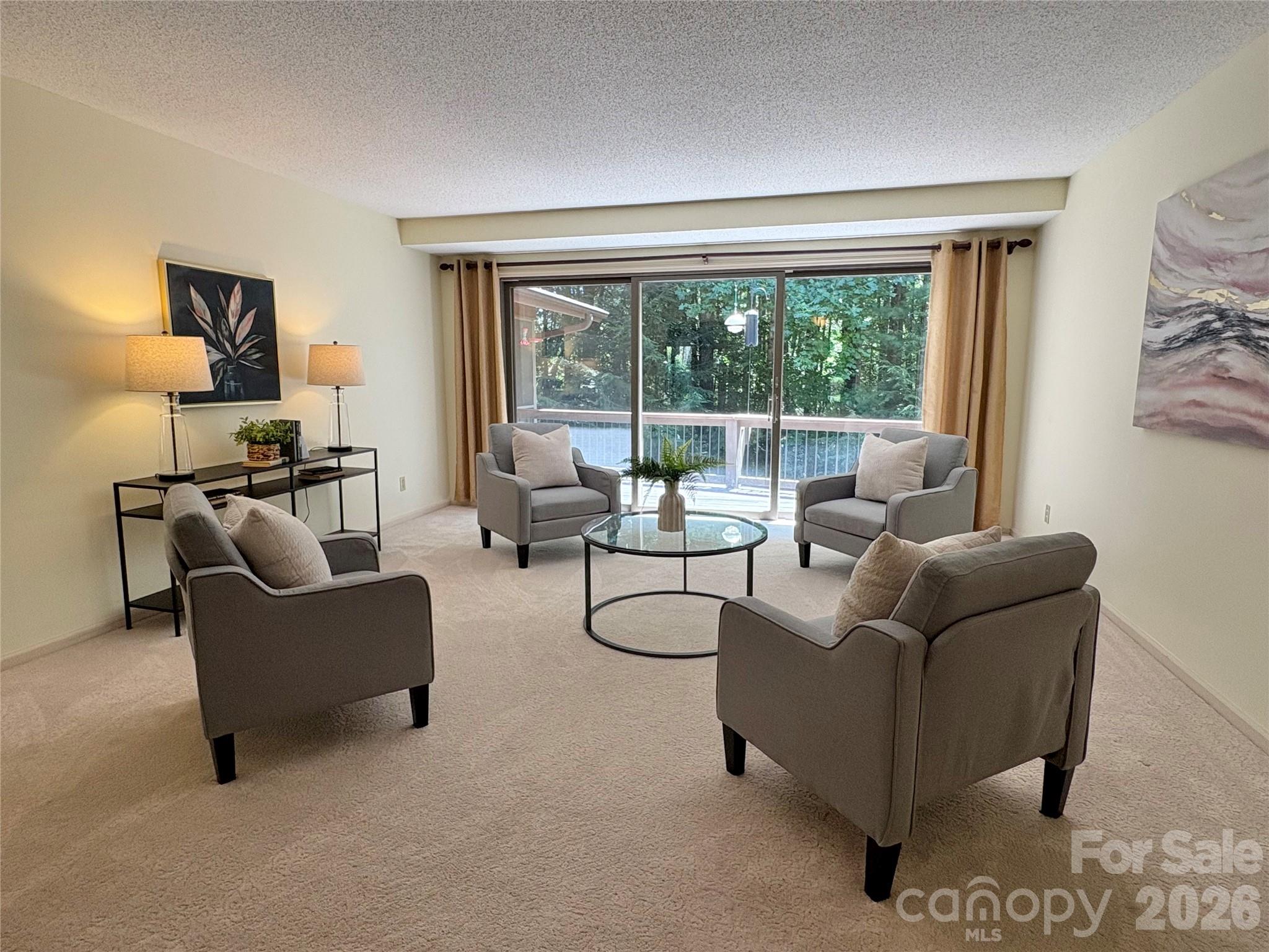 from foyer, looking toward Formal Living Room with wall of glass doors that open to Deck - 115 Woodhaven Drive, Hendersonville