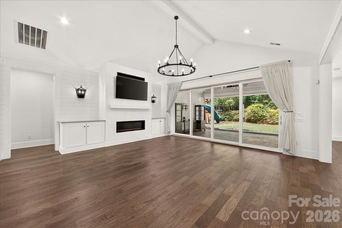 Spacious Great room has prefinished hardwood flooring, vaulted ceiling, stacking sliding doors to a large porch area with motorized screen - 3142 Sherman Drive, Lancaster