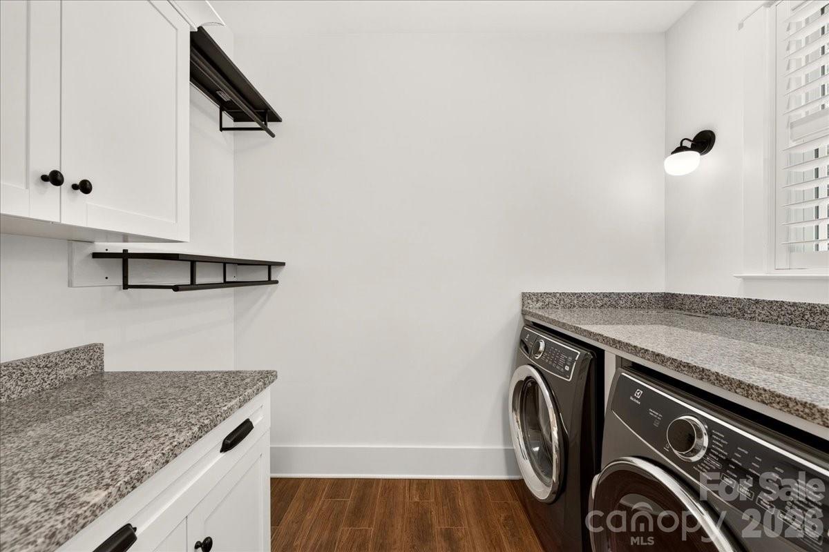 This home has 2 laundry rooms! This one is on the main level right off the owners closet for convenience- hanging area, cabinets for storage and granite counter tops Washer, dryer remain - 3142 Sherman Drive, Lancaster
