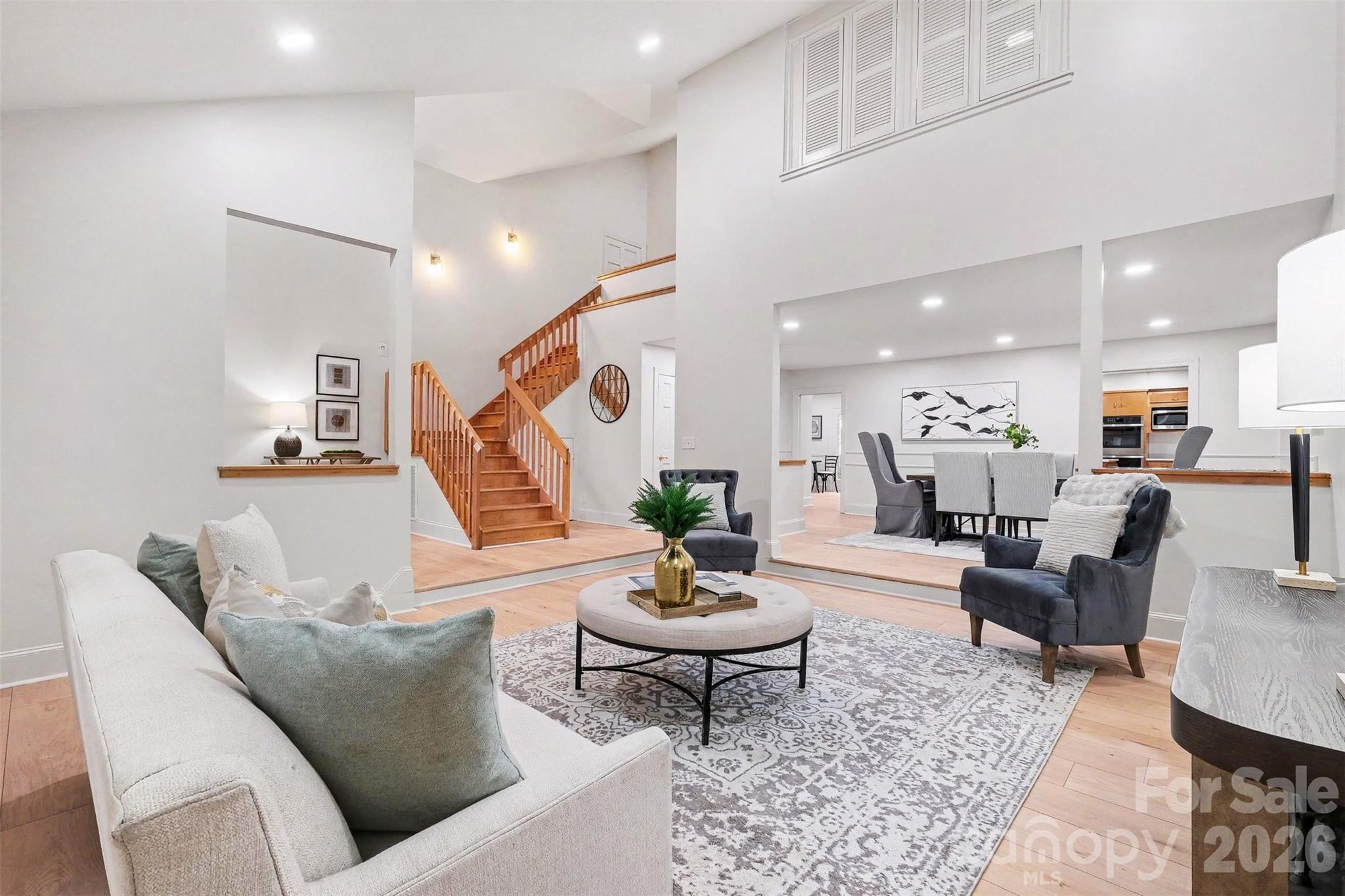What a wonderful from the living room, into the dining room and the foyer and the gorgeous stairs to the upper level. - 5042 Marci Lane, Belmont