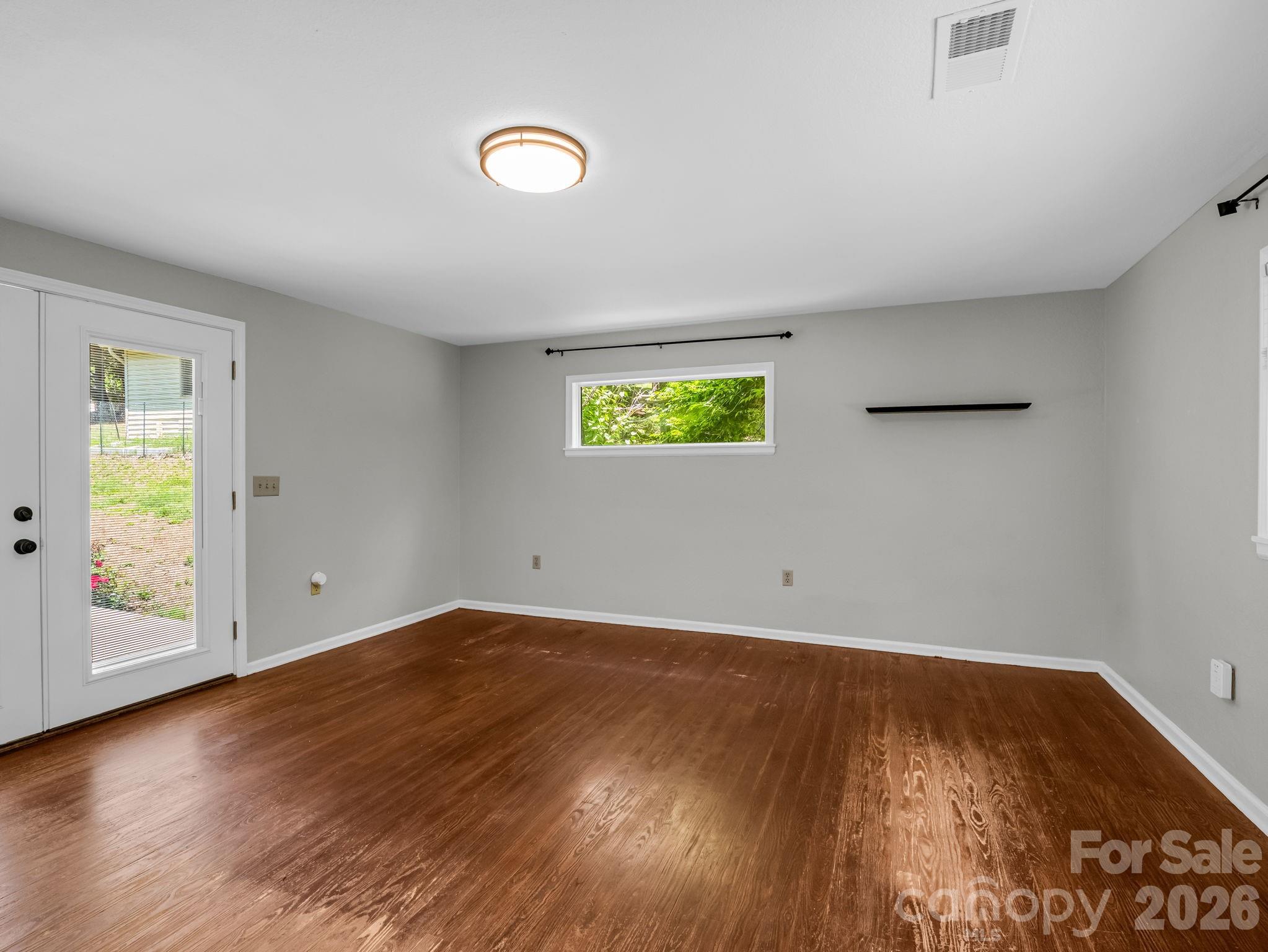 Family Room off of Living Room, doors open to back patio - 35 Chastain Hill Road, Mills River