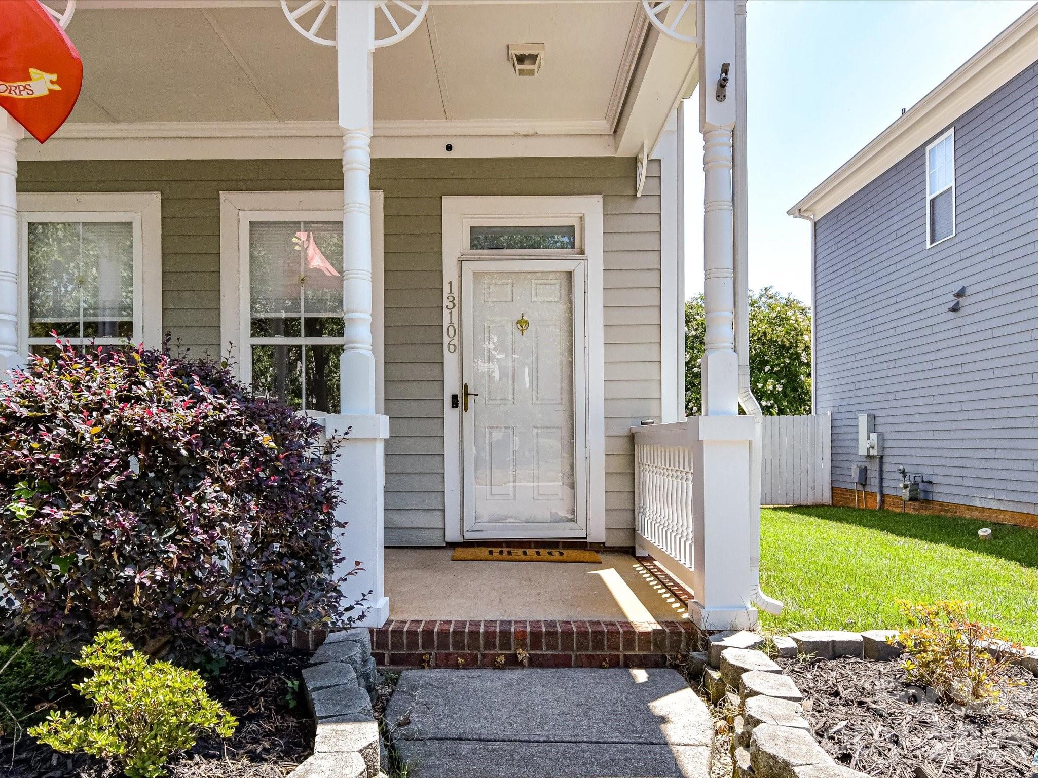 Relax and unwind on the welcoming covered front porch, the perfect spot to enjoy morning coffee or greet guests. - 13106 Kennerly Drive, Huntersville