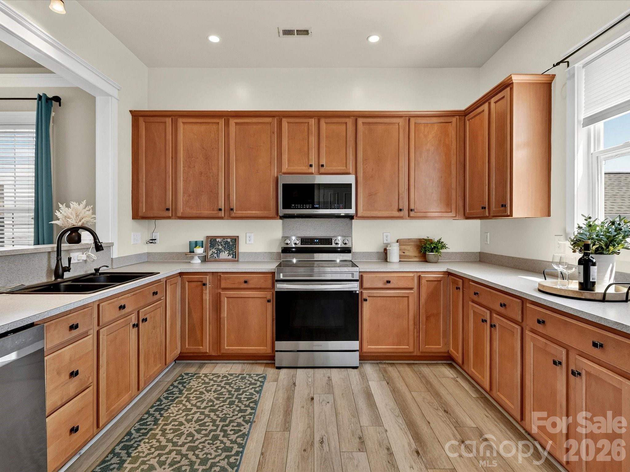 The spacious kitchen features abundant cabinetry, generous counter space, stainless steel appliances, recessed lighting, and an open layout designed for effortless everyday living and entertaining. - 13106 Kennerly Drive, Huntersville