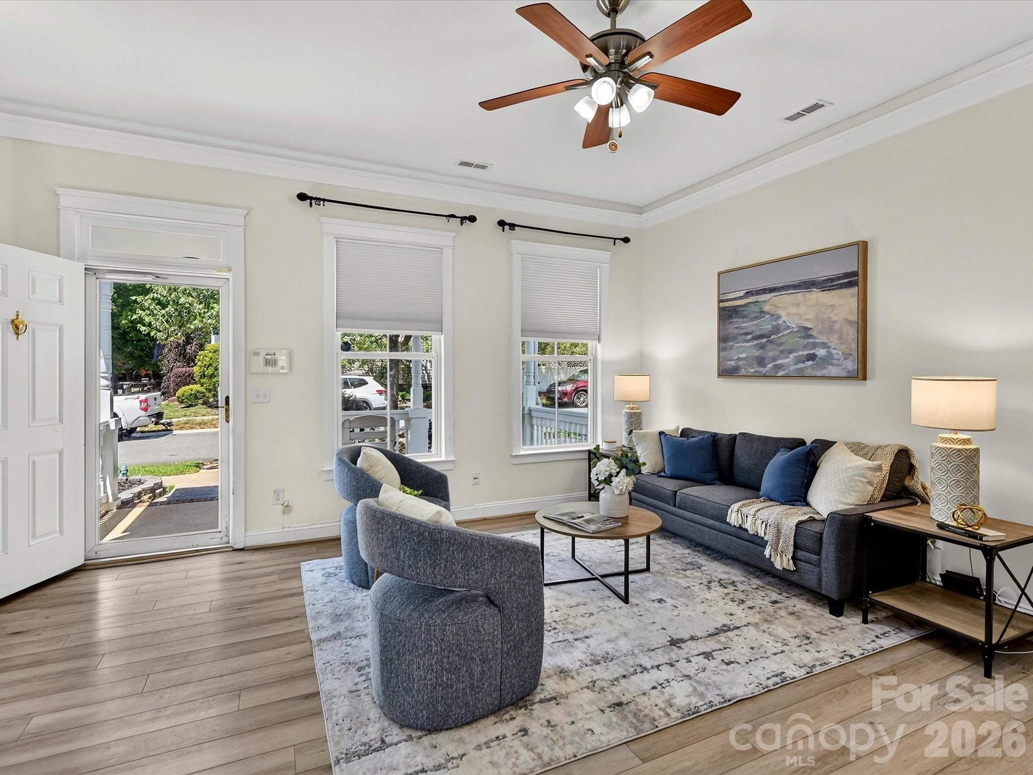 Designed for both comfort and functionality, the light-filled Great Room features a gas fireplace, crown molding, and an open layout that flows effortlessly into the home's gathering spaces. - 13106 Kennerly Drive, Huntersville