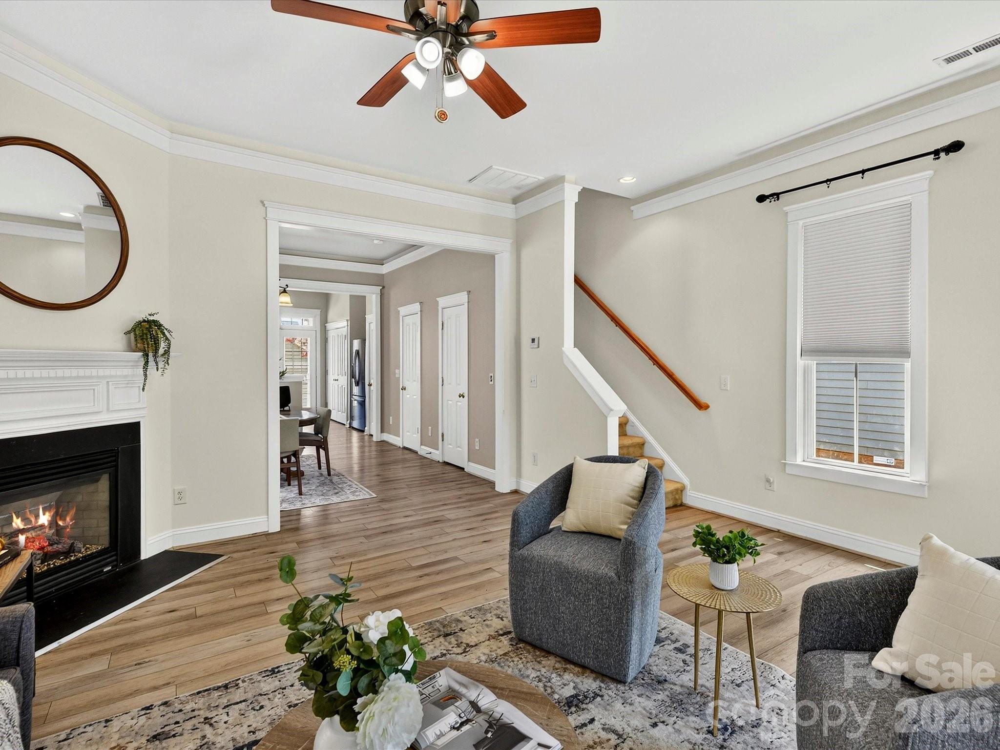 Designed for both comfort and functionality, the light-filled Great Room features a gas fireplace, crown molding, and an open layout that flows effortlessly into the home's gathering spaces. - 13106 Kennerly Drive, Huntersville
