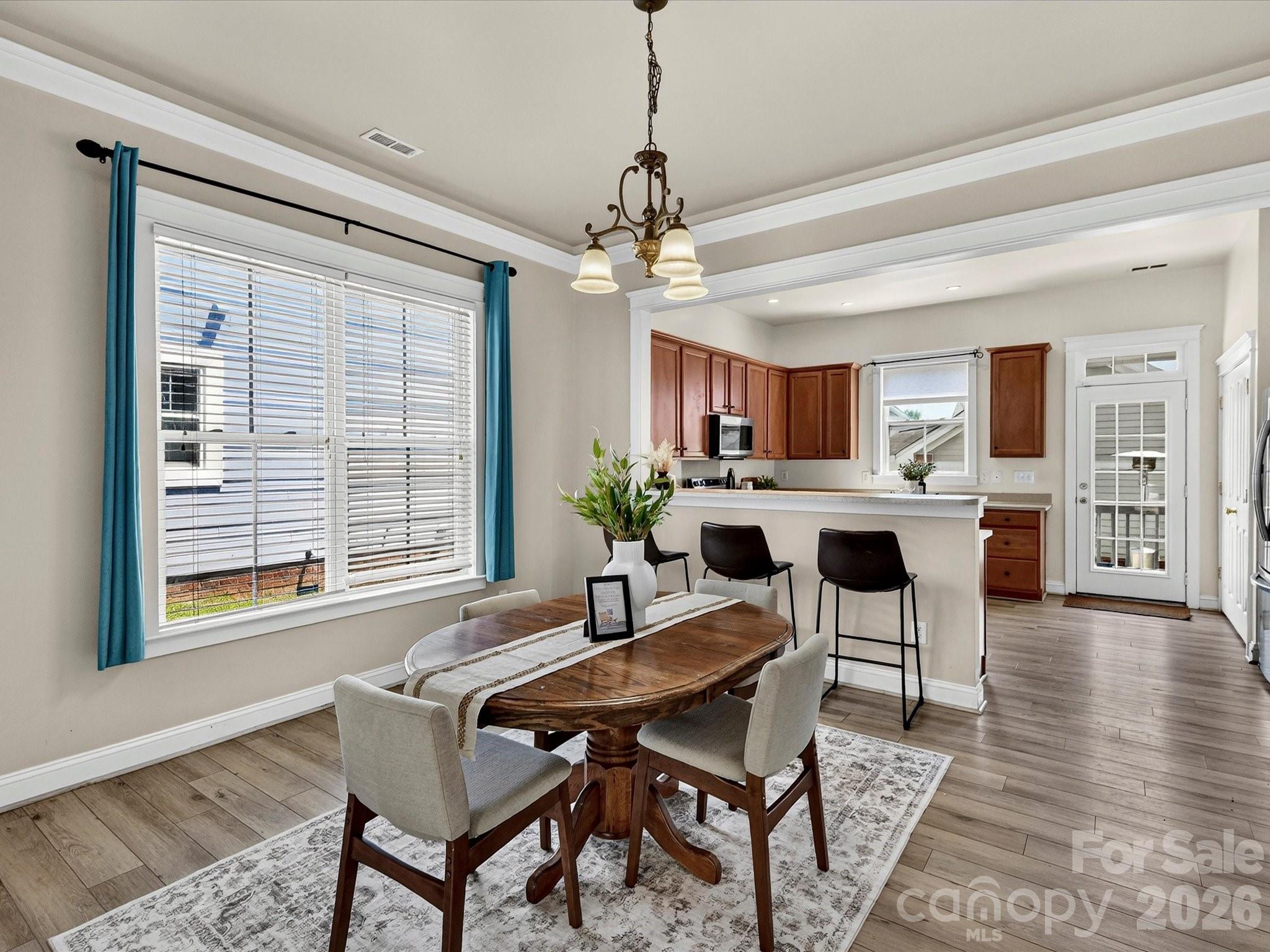 Perfectly positioned between the kitchen and living spaces, the spacious dining area offers stylish architectural details and ample room for hosting family dinners or entertaining guests. - 13106 Kennerly Drive, Huntersville