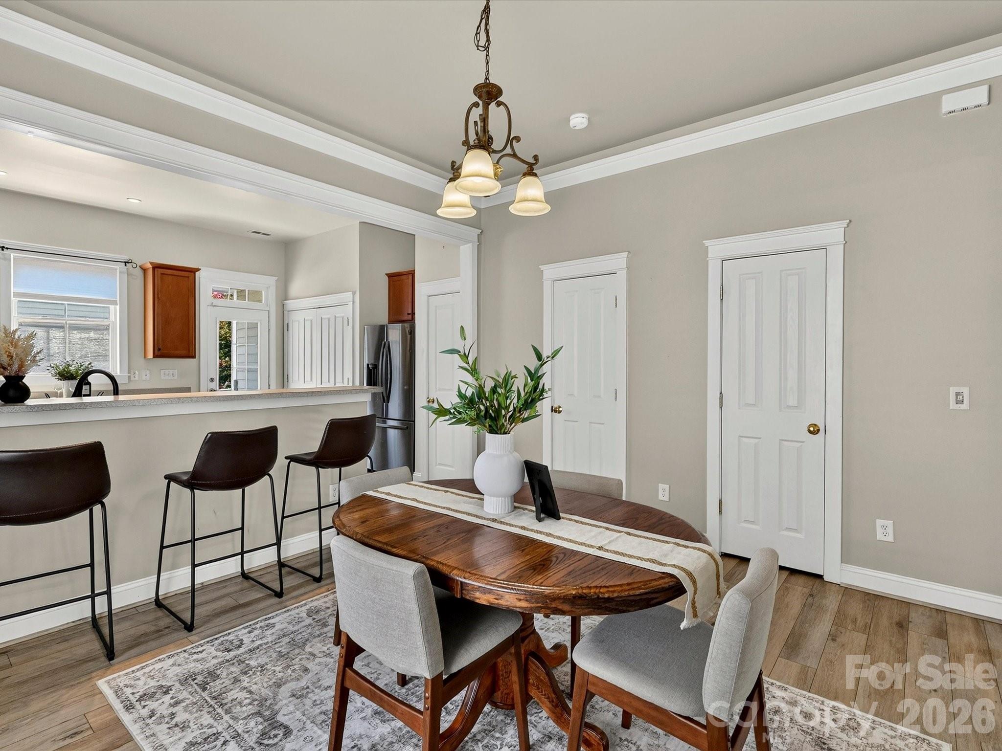 Perfectly positioned between the kitchen and living spaces, the spacious dining area offers stylish architectural details and ample room for hosting family dinners or entertaining guests. - 13106 Kennerly Drive, Huntersville