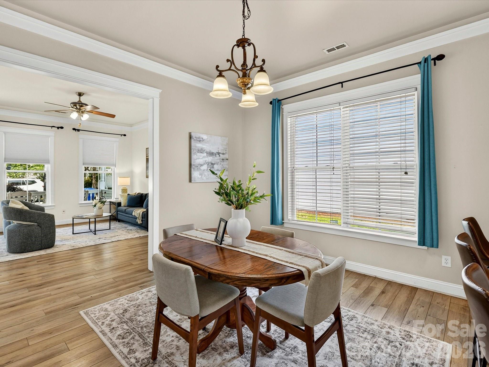 Enjoy a welcoming dining space highlighted by oversized windows, decorative trim, and seamless access to the kitchen, creating an effortless flow for everyday living and special occasions. - 13106 Kennerly Drive, Huntersville