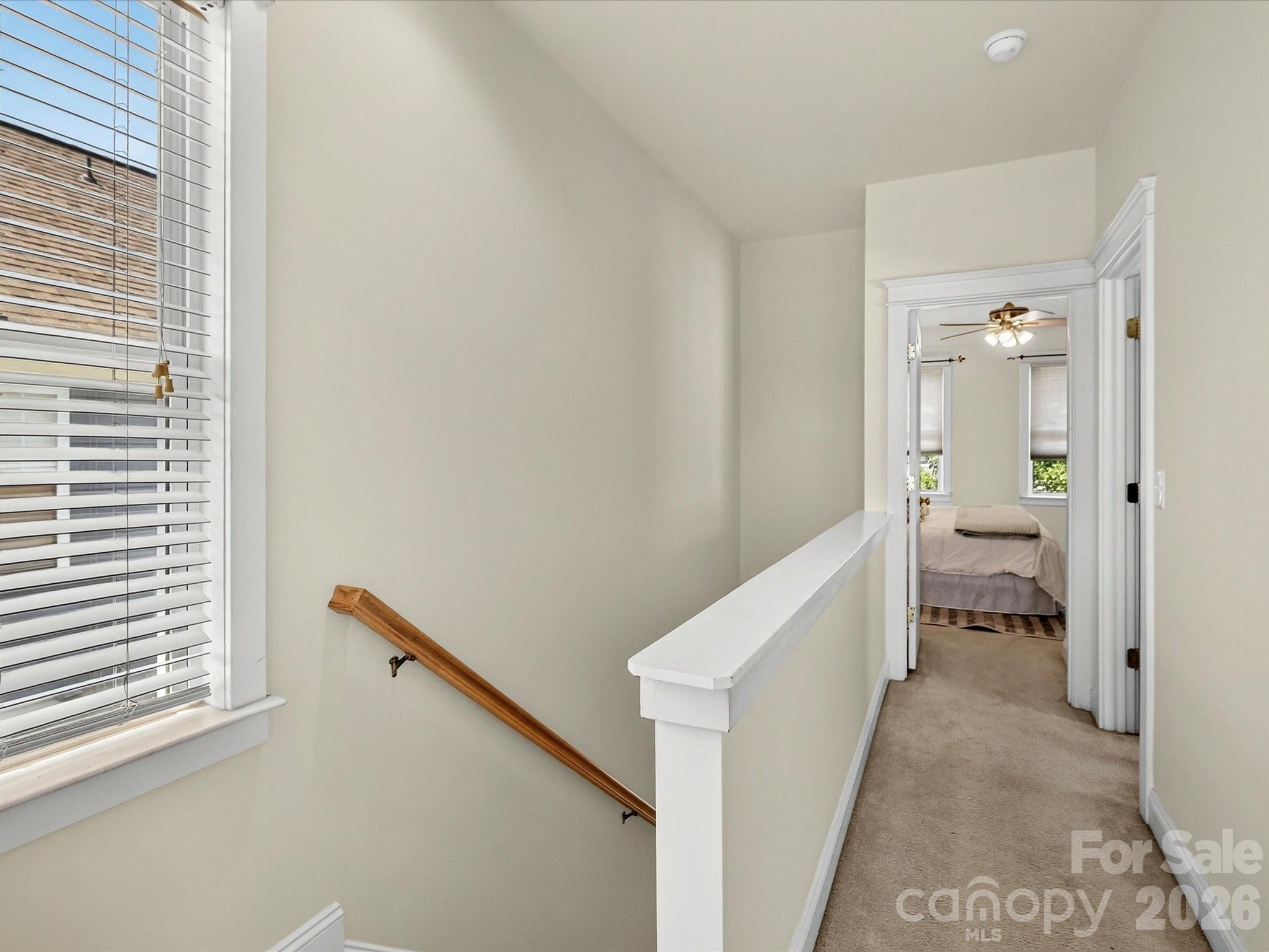 The upper-level landing provides easy access to the secondary bedrooms and creates a functional layout with an open view overlooking the staircase below. - 13106 Kennerly Drive, Huntersville