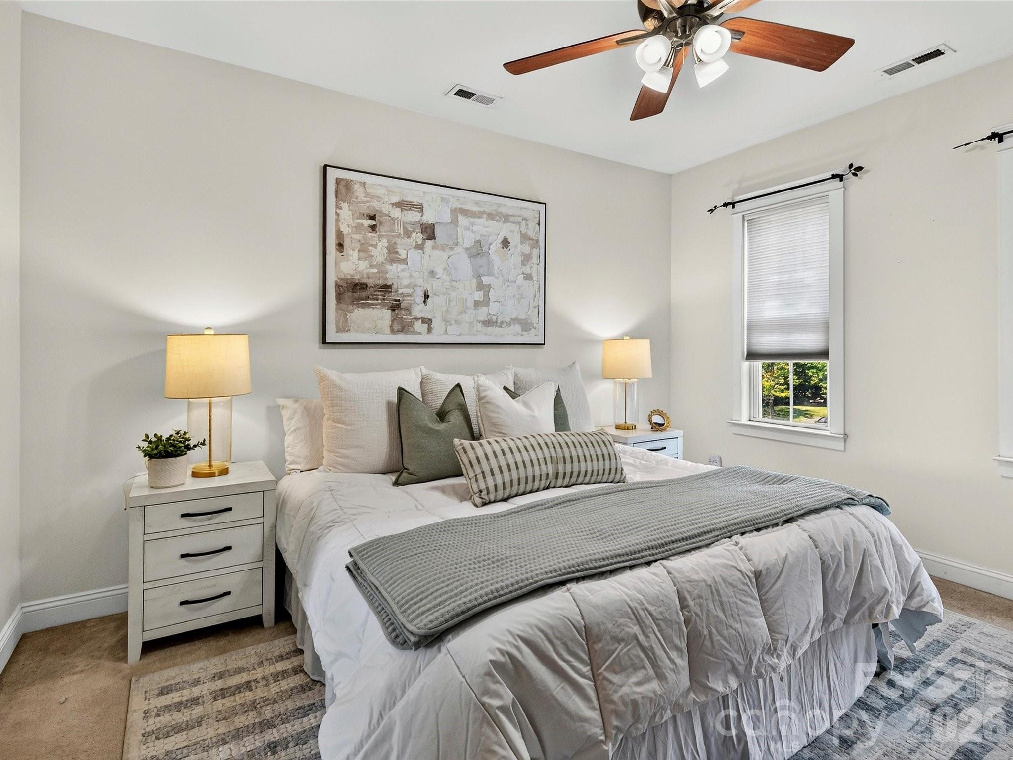 Retreat to the spacious primary suite featuring abundant natural light, a ceiling fan, walk in closet, ensuite bath and a peaceful atmosphere designed for everyday comfort. - 13106 Kennerly Drive, Huntersville