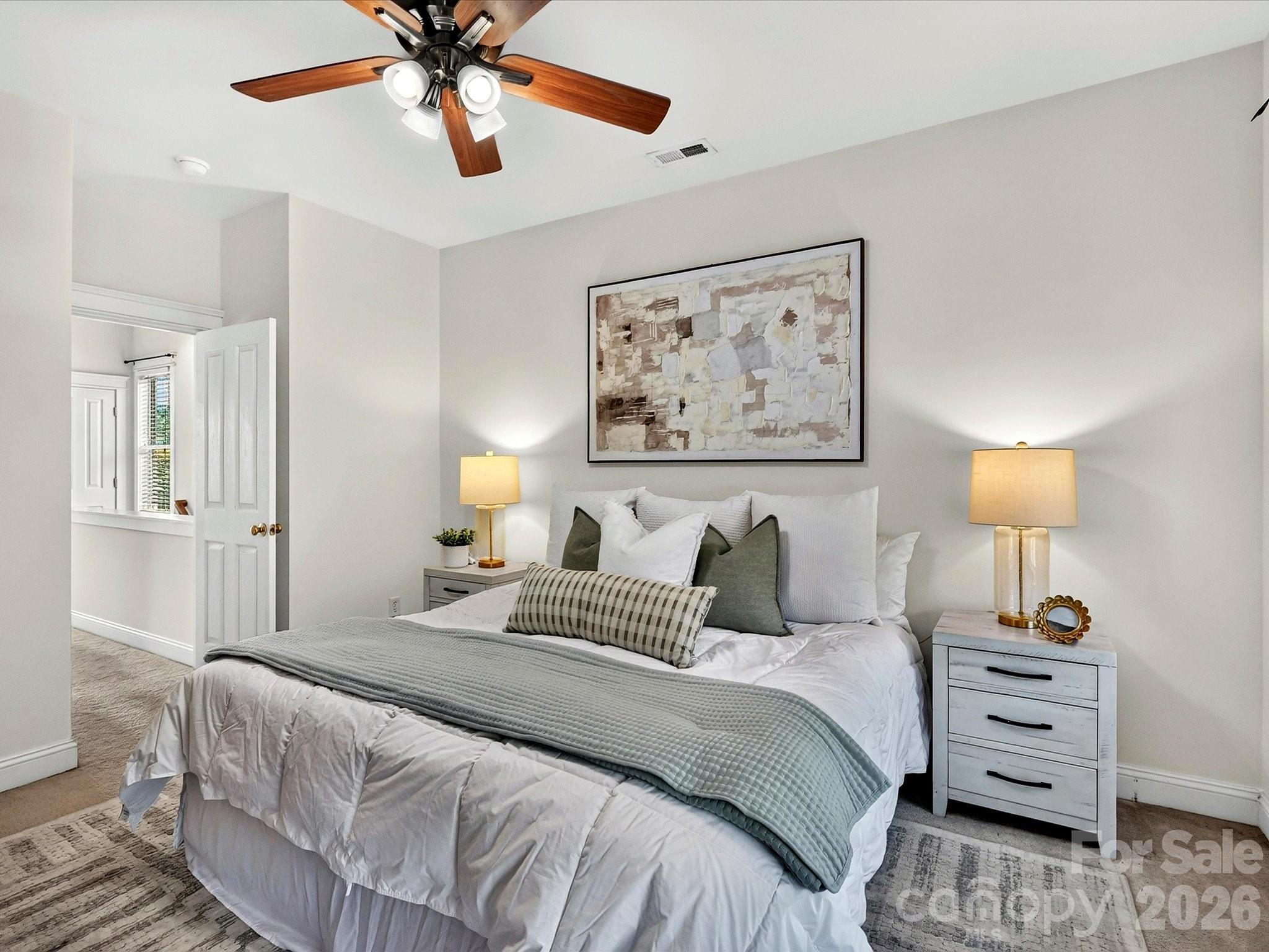 The inviting primary bedroom offers a relaxing escape with large windows, ample space for full-size furnishings, and a bright, airy feel. - 13106 Kennerly Drive, Huntersville