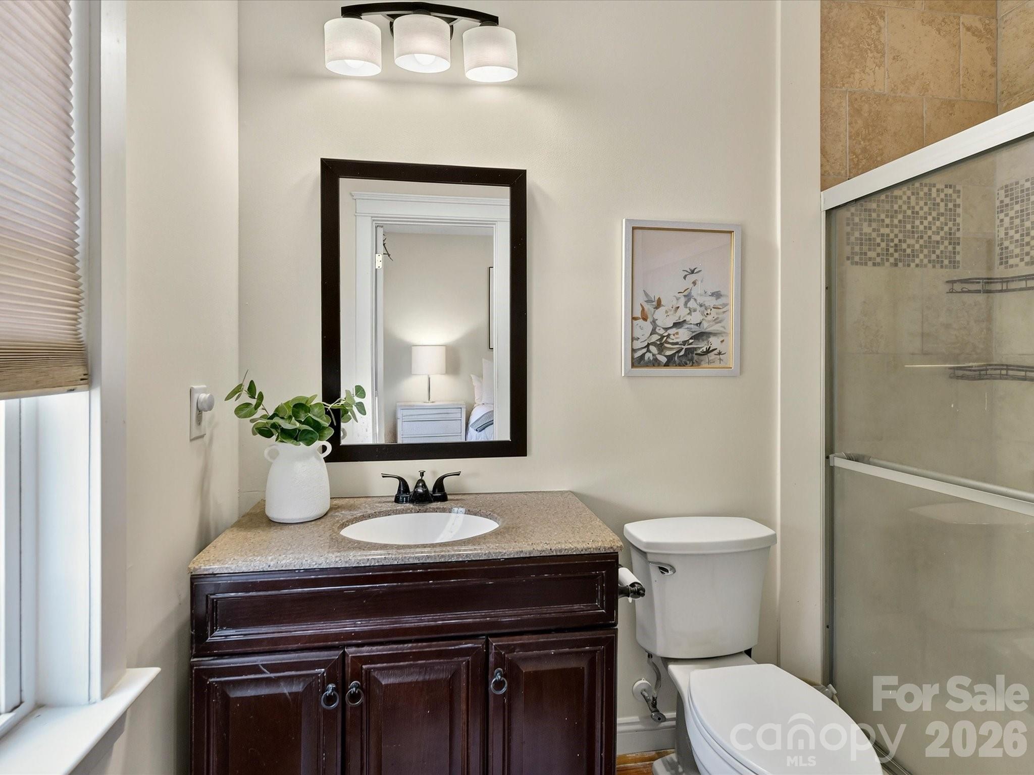 The private primary bath features a spacious vanity with abundant counter space, a walk-in shower, and a bright, functional layout. - 13106 Kennerly Drive, Huntersville