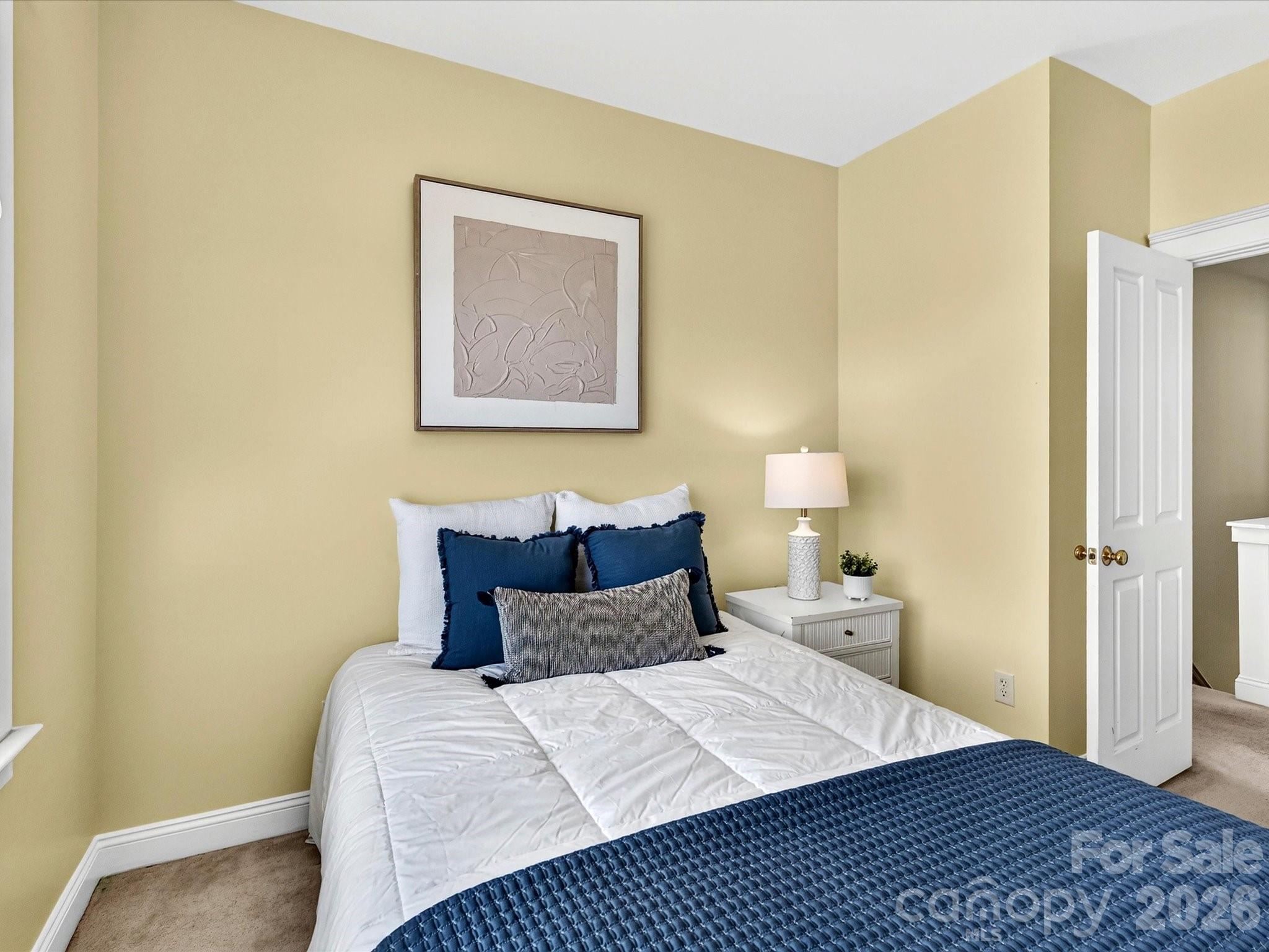 Bedroom 2 provides a comfortable retreat with a spacious closet, soft natural light, and direct access to the nearby full bath. - 13106 Kennerly Drive, Huntersville