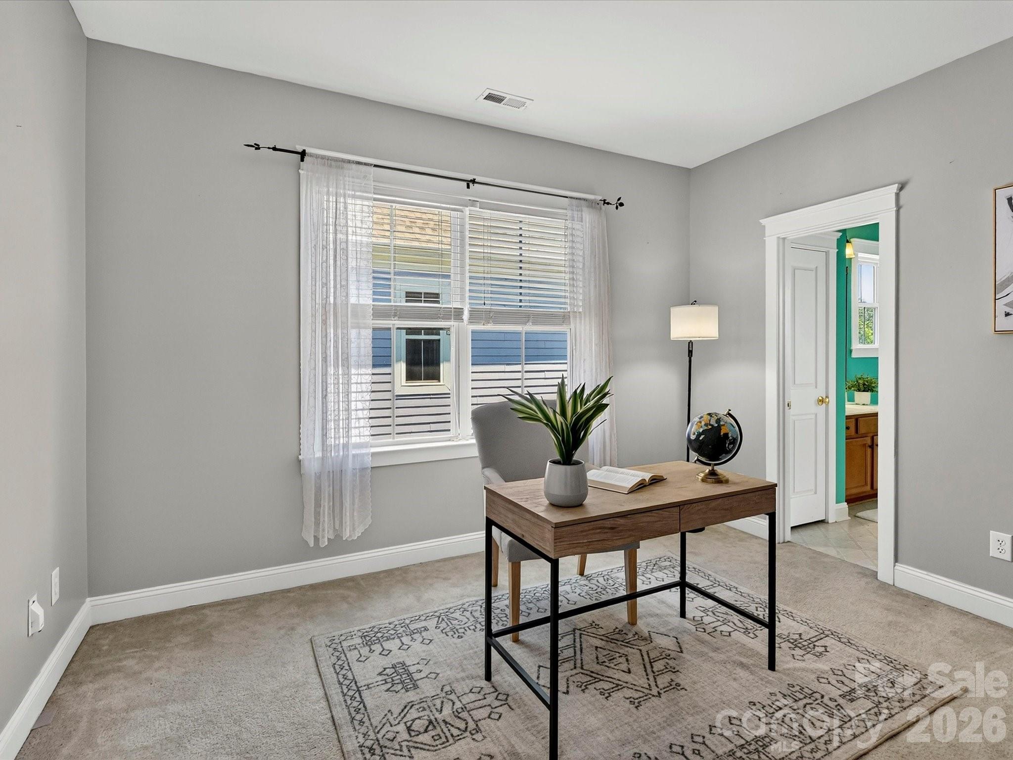 Bedroom 3 offers flexible living space ideal for guests, a home office, or hobbies, complete with generous natural light and convenient access to the adjacent full bath. - 13106 Kennerly Drive, Huntersville