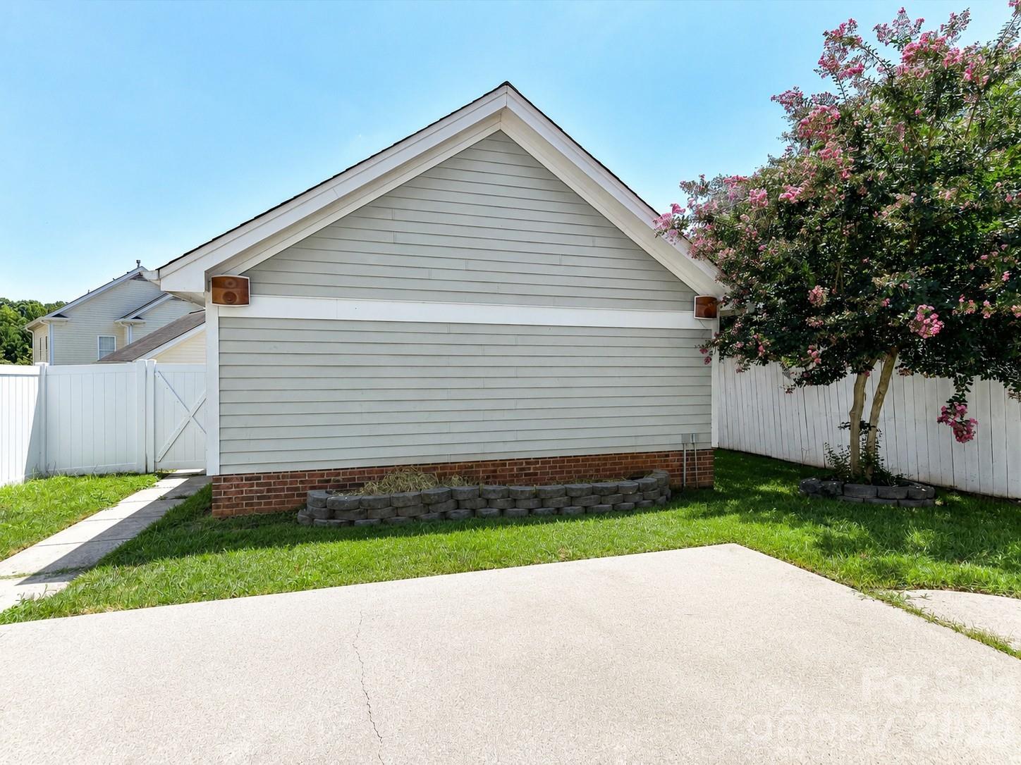 Detached two-car garage provides excellent space for parking, storage, or hobbies and is conveniently accessed from the fully fenced backyard. - 13106 Kennerly Drive, Huntersville