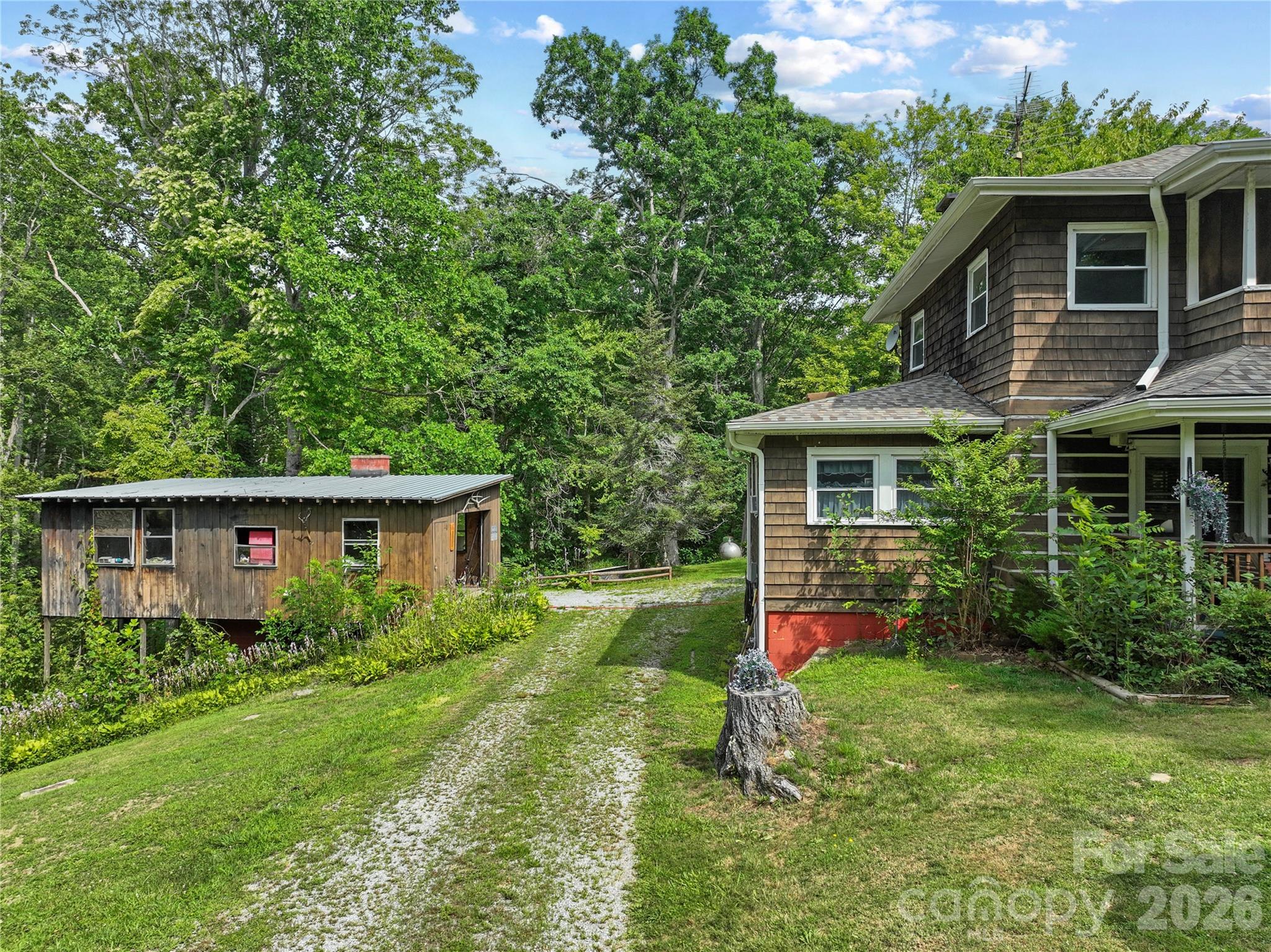 Side view with detached garage - 3151 N Bearwallow Road, Hendersonville