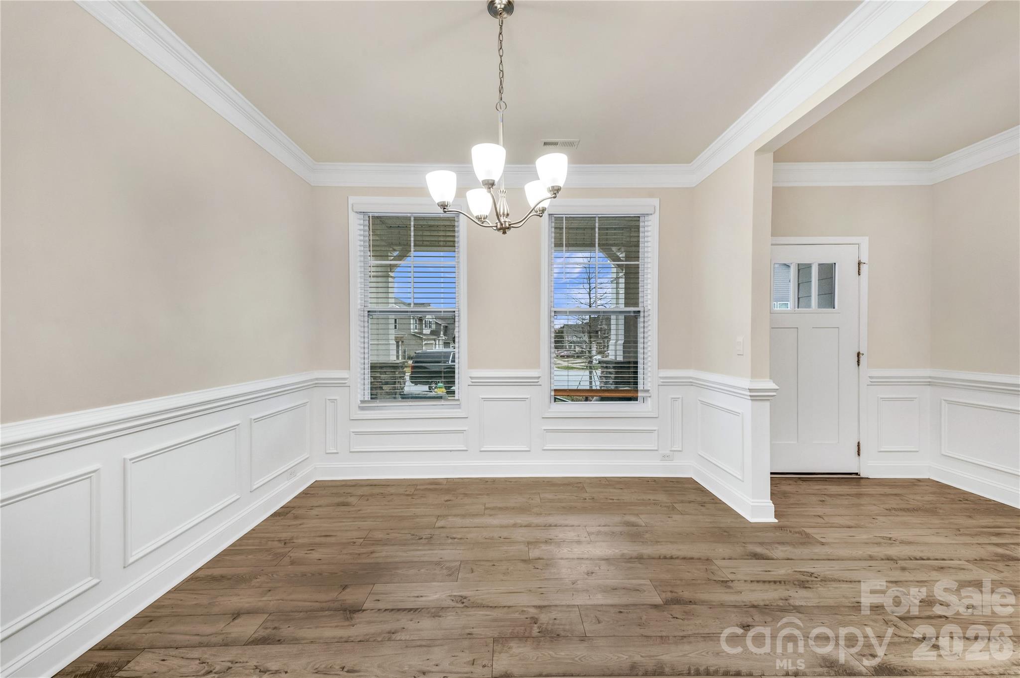 The formal dining room features refined crown molding, custom trim work and premium flooring. Its the perfect blend of high-end style and functional flow, situated just steps from kitchen - 4849 Tacoma Drive, Fort Mill