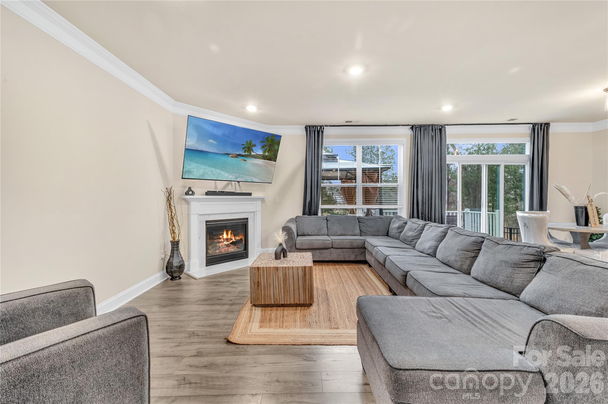 Living room with oversized windows looking into the beautiful tree-lined backyard - 4849 Tacoma Drive, Fort Mill