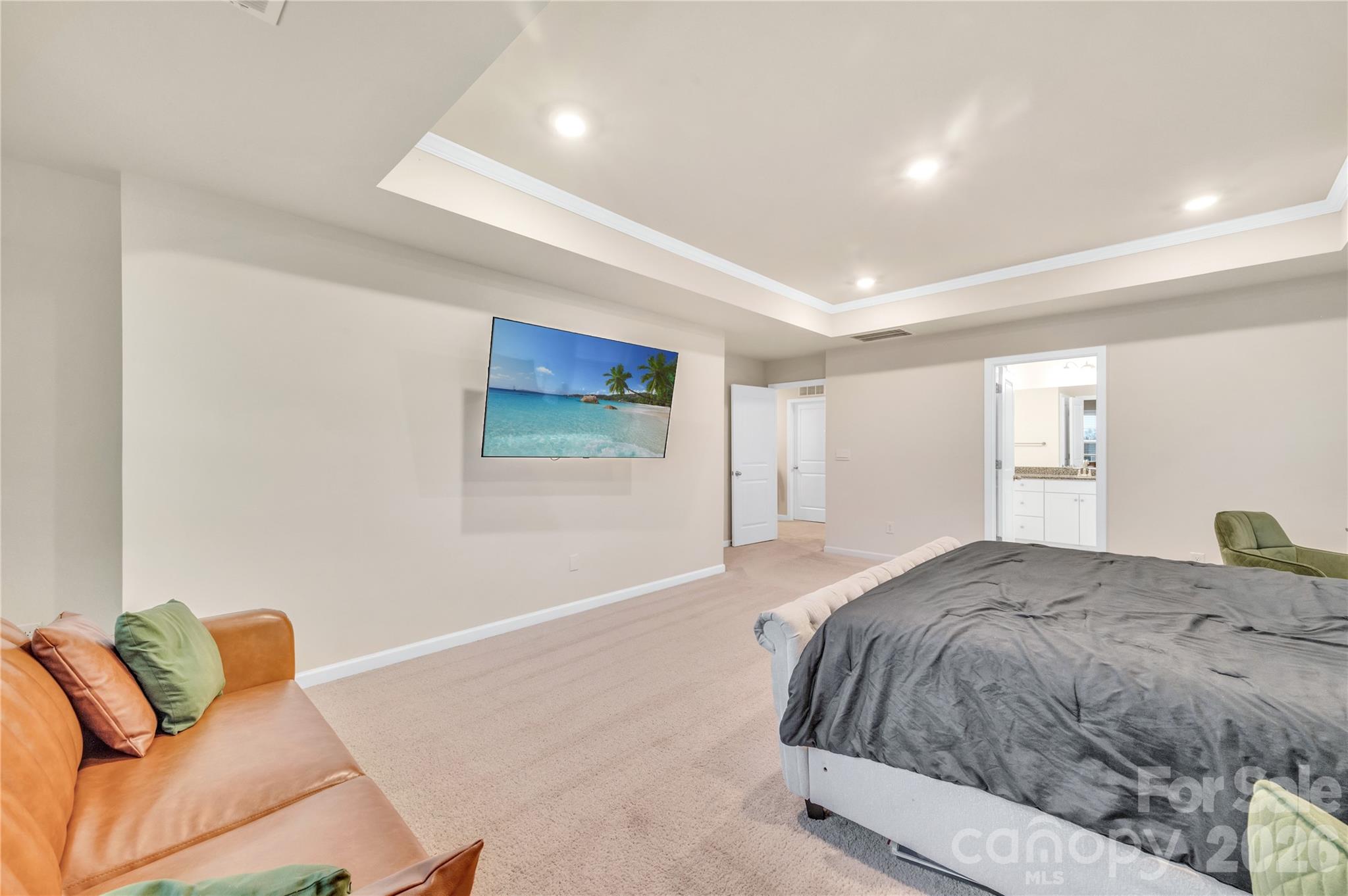 The Primary bedroom offers more than enough square footage to comfortably fit a king bed, a dedicated living/seating area and workspaces without feeling crowded - 4849 Tacoma Drive, Fort Mill