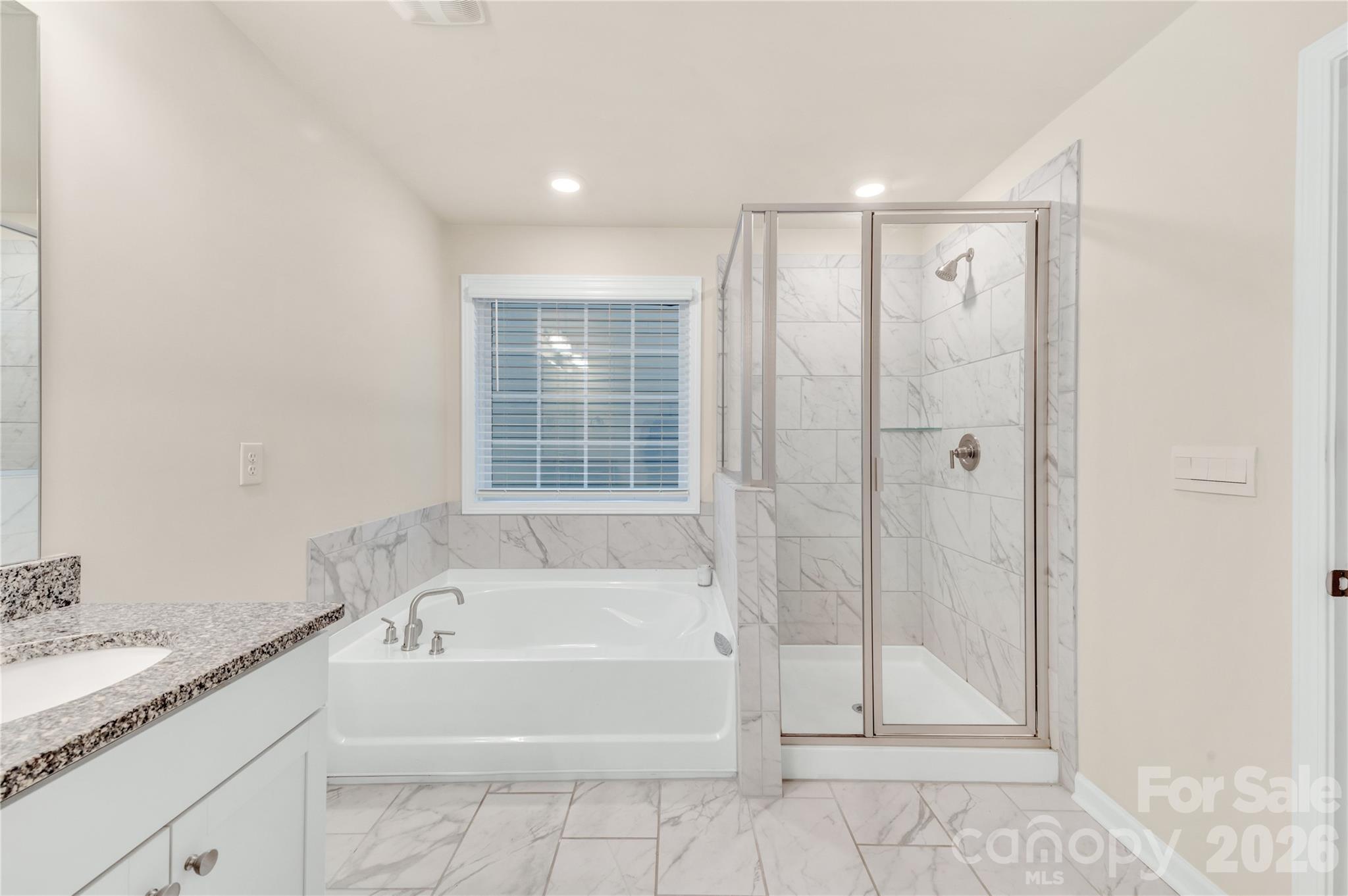 Complete with both a relaxing soaking tub and a separate glass shower. This bright and airy space combines everyday functionality with high-end design - 4849 Tacoma Drive, Fort Mill