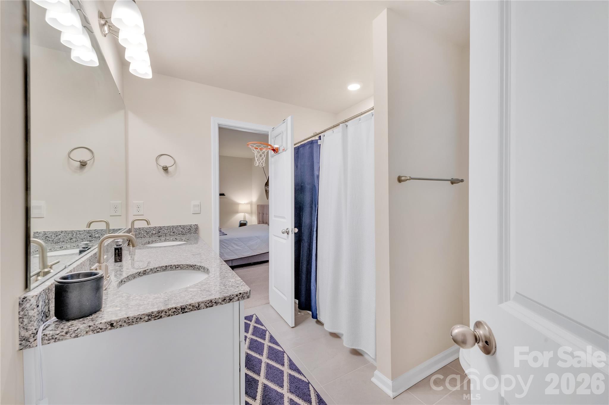 This high-desirable Jack and Jill bathroom connects two secondary bedrooms, providing effortless shared access while preserving privacy - 4849 Tacoma Drive, Fort Mill