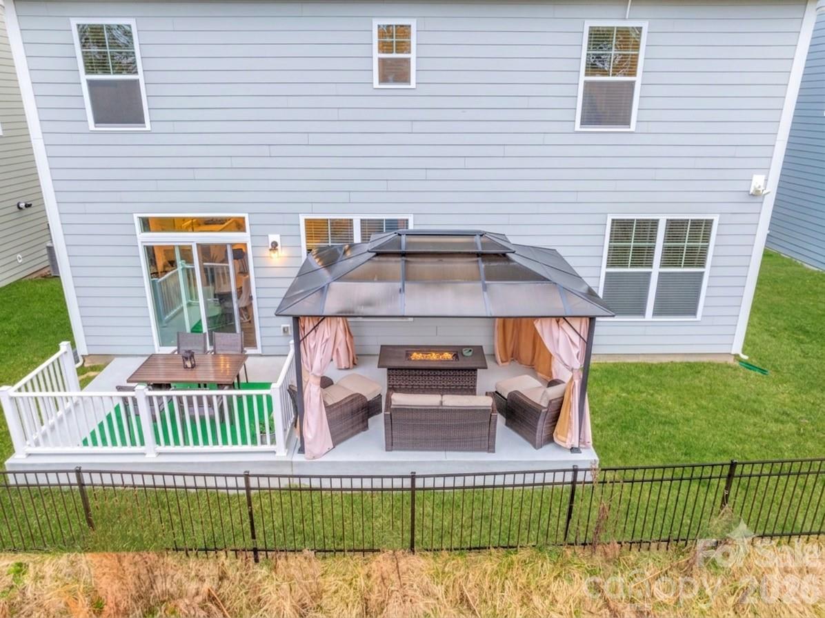 This expansive deck offers a seamless blend of open-air dining and cozy-sheltered relaxation - 4849 Tacoma Drive, Fort Mill