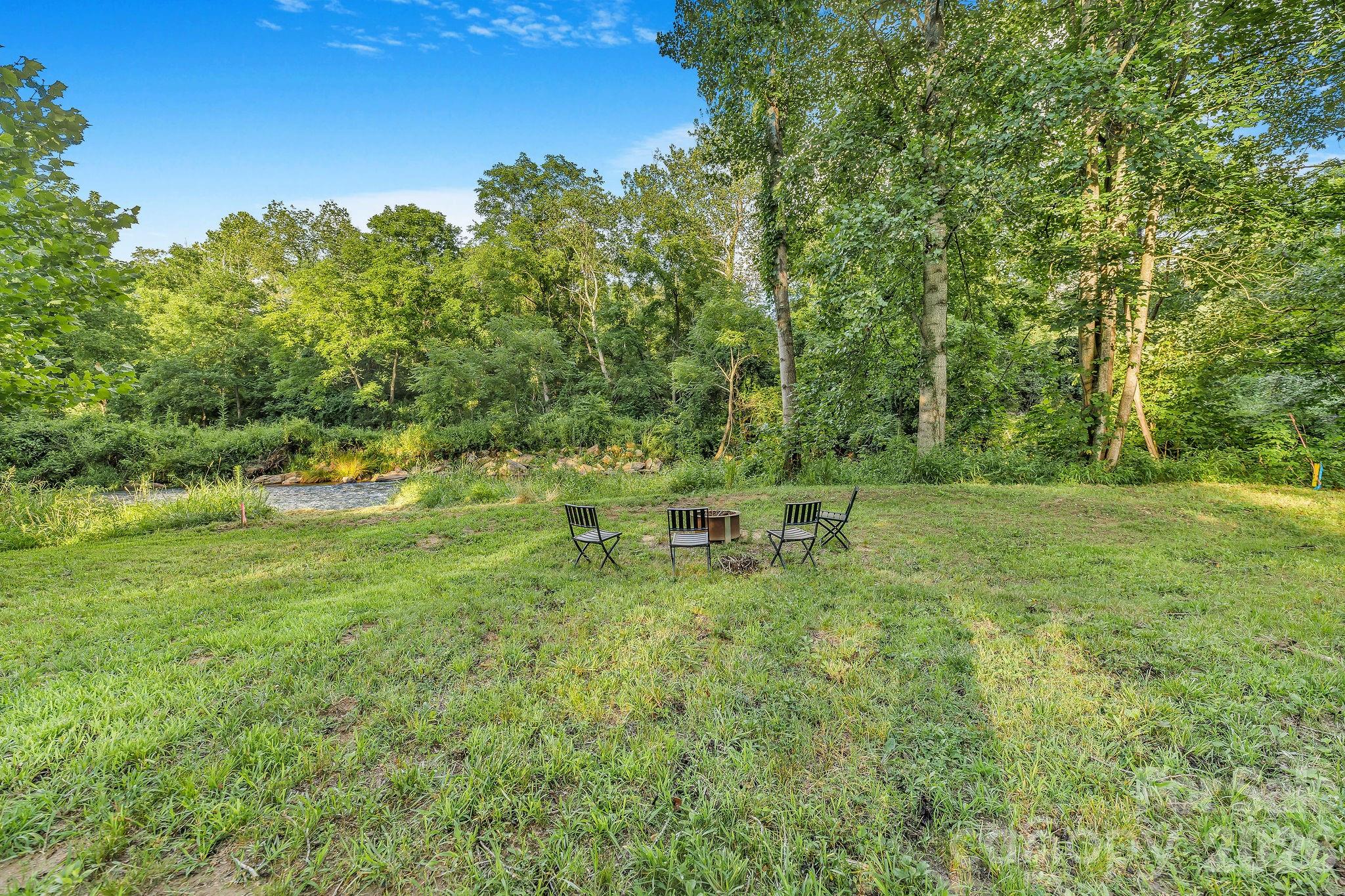 Enjoy conversations at the fire pit beside the creek. - 1182 Crabtree Road, Waynesville