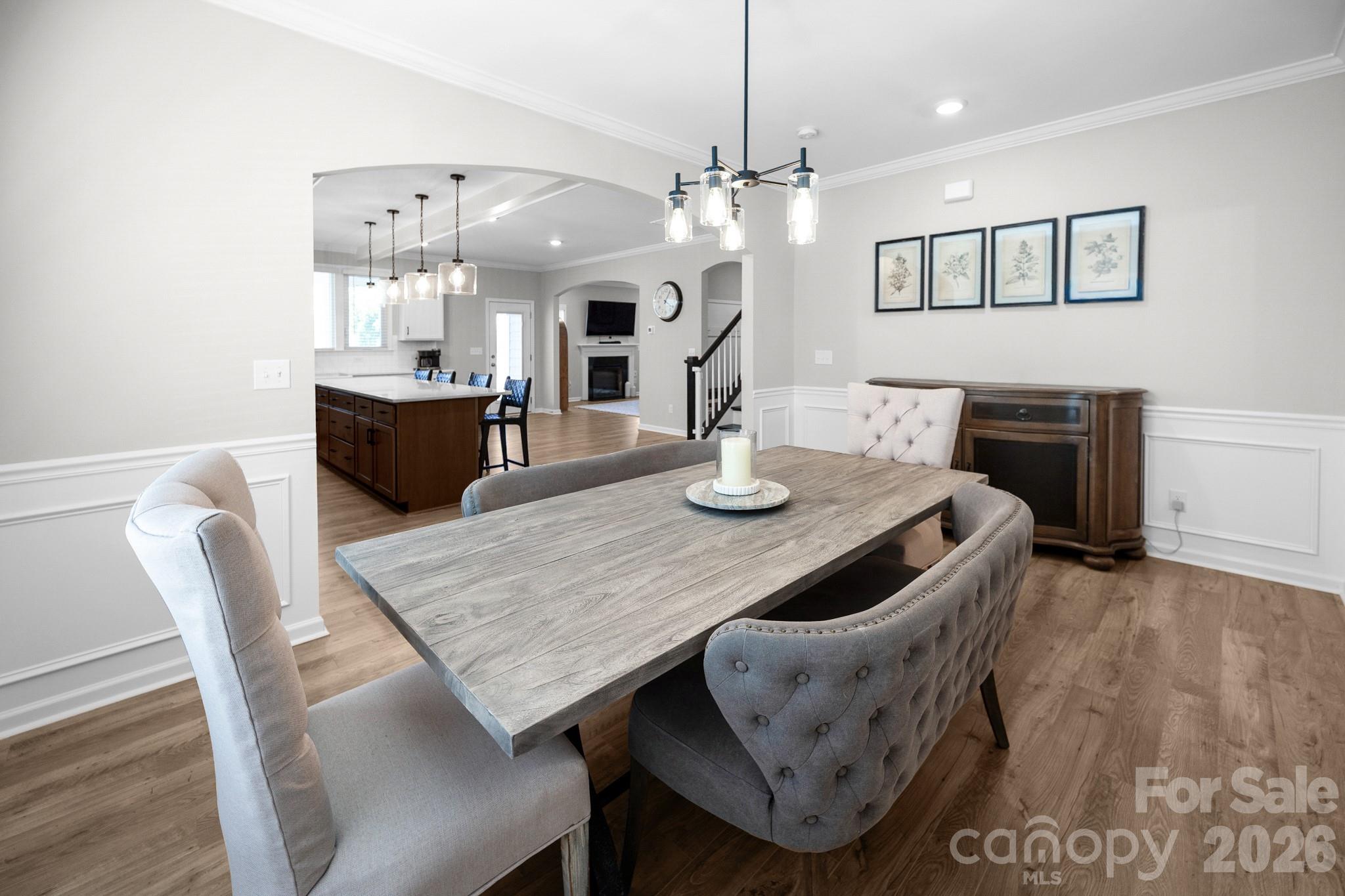 Dedicated dining area with open access to the kitchen and the living area through upgraded arched openings - 5080 Mooreland Oaks Way, Mount Holly