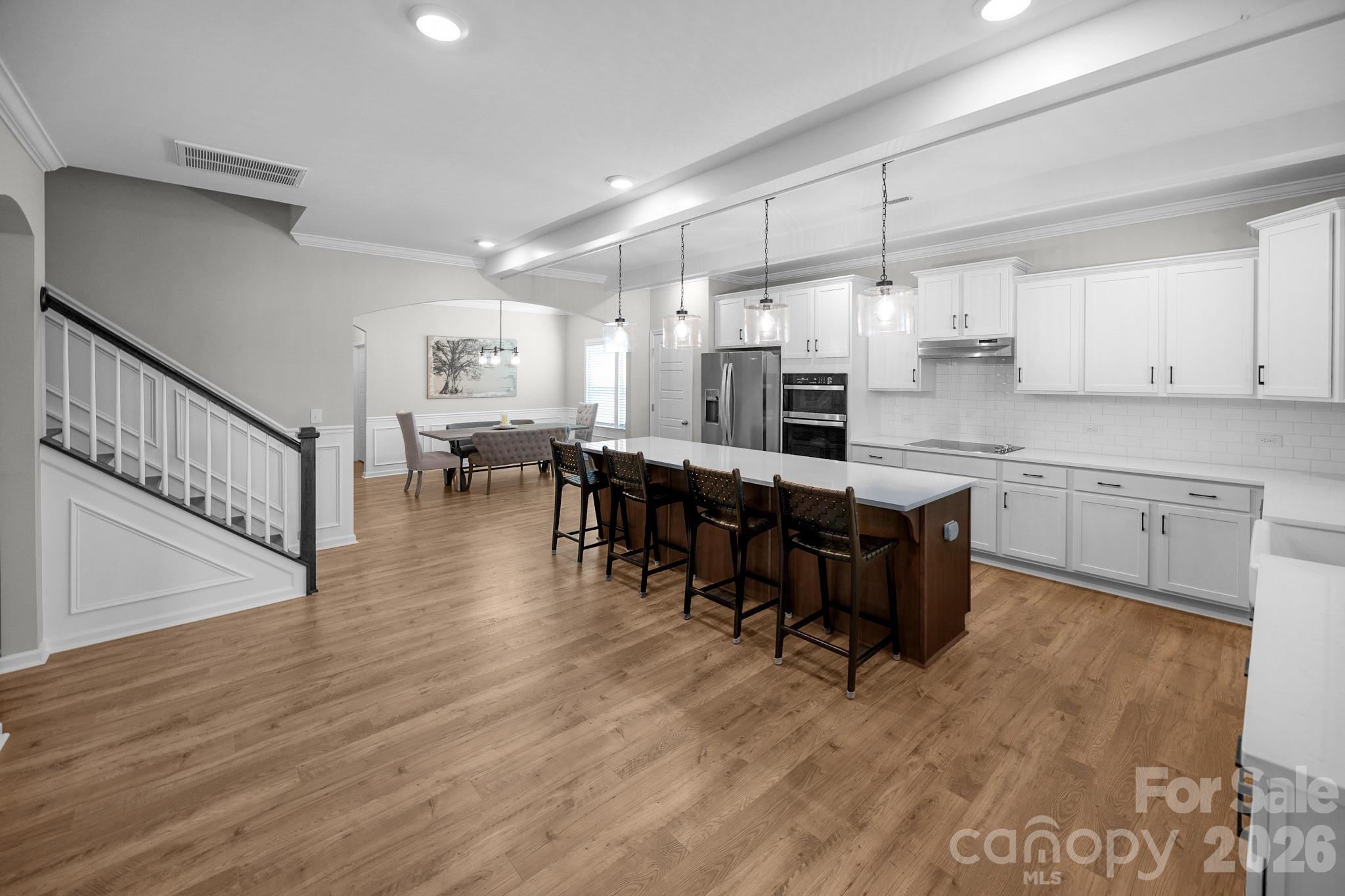 Large kitchen island provides plenty of space for prep and gathering around the kitchen - 5080 Mooreland Oaks Way, Mount Holly