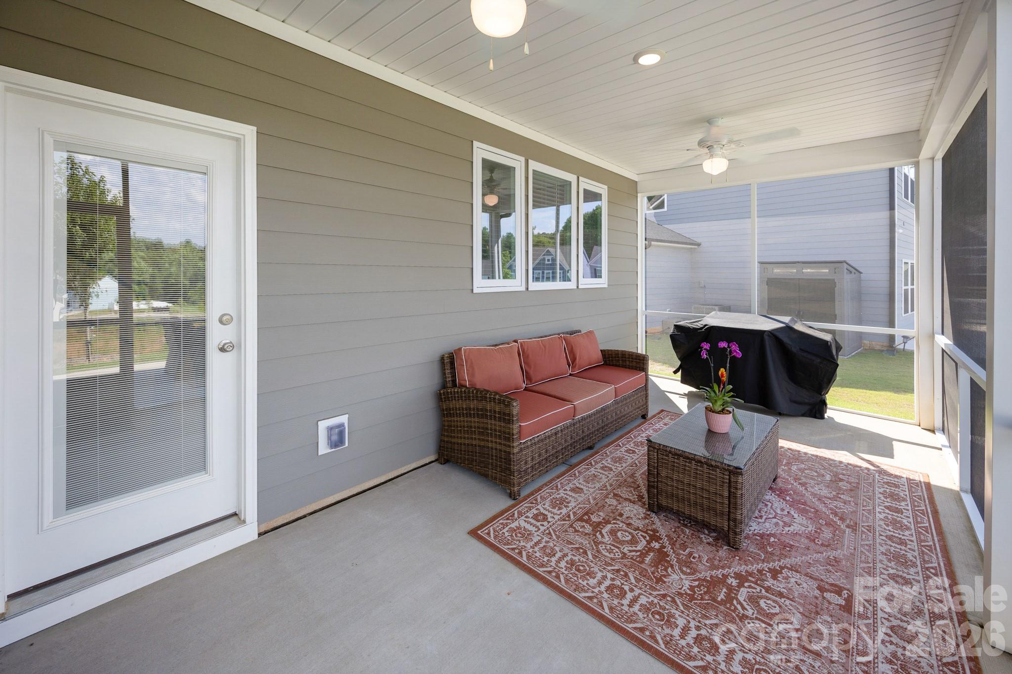 Access the screened in back patio from the kitchen and/or the living room back door - 5080 Mooreland Oaks Way, Mount Holly