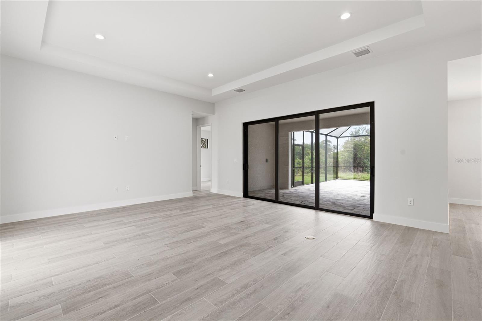 Open Living Room with Seamless Indoor-Outdoor Flow - 14319 ALLENSWORTH AVE, PORT CHARLOTTE