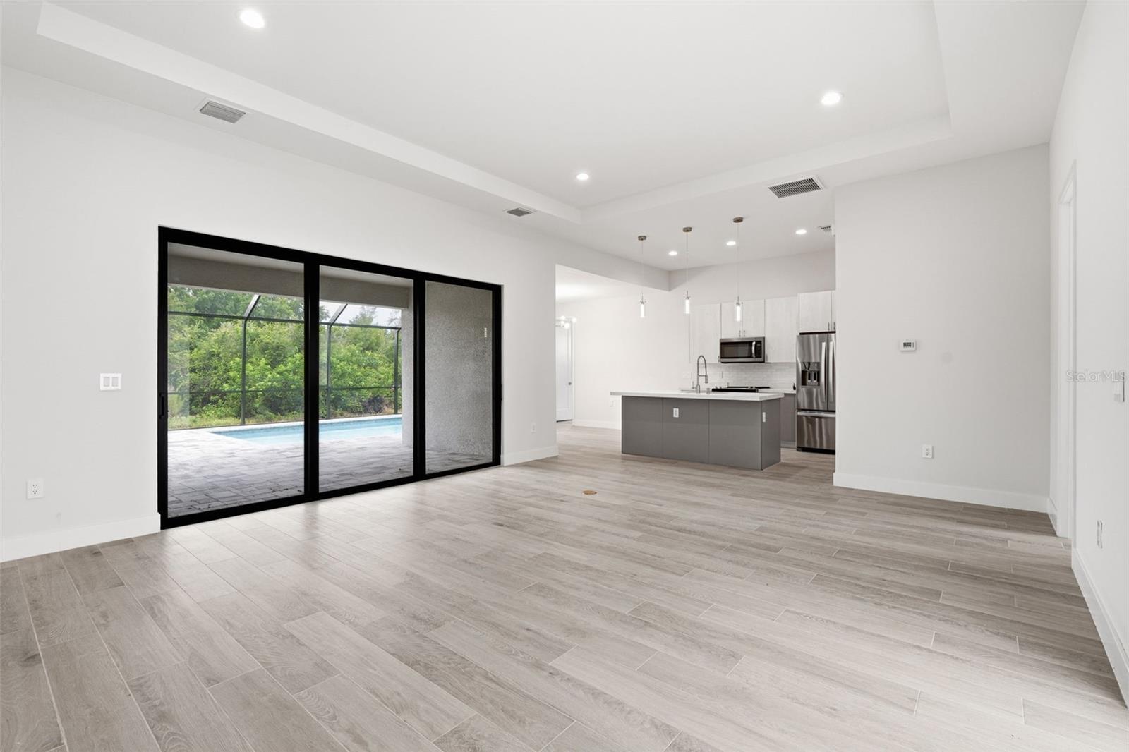 Open Living Room with Seamless Indoor-Outdoor Flow - 14319 ALLENSWORTH AVE, PORT CHARLOTTE