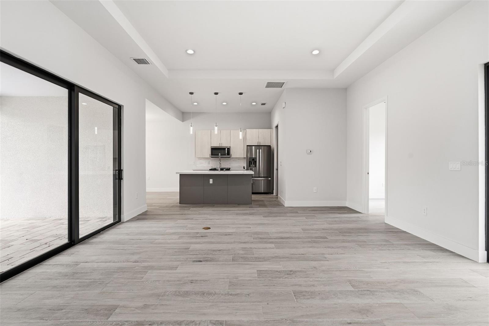 Open Living Room with Seamless Indoor-Outdoor Flow - 14319 ALLENSWORTH AVE, PORT CHARLOTTE