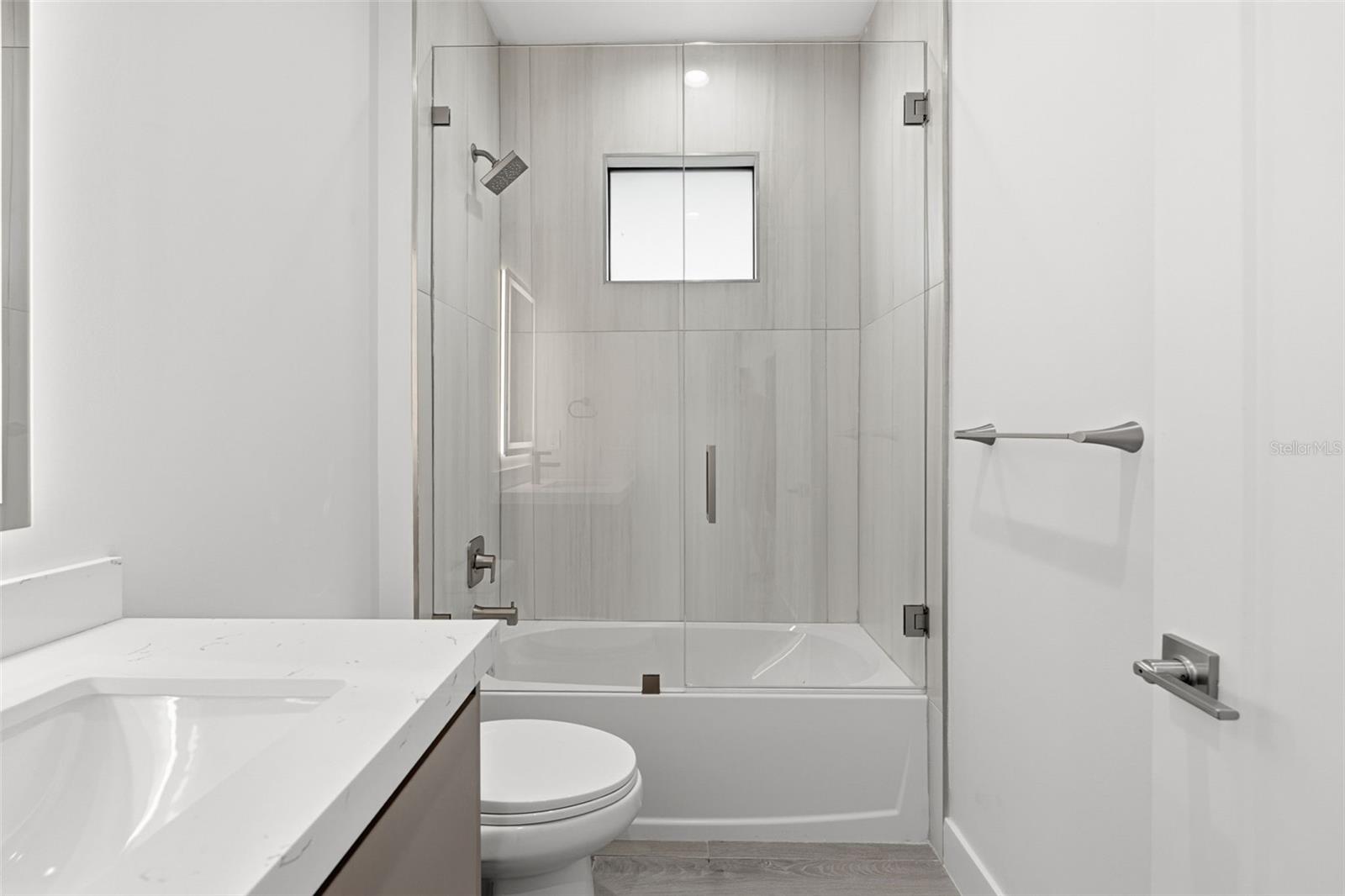 Guest Bathroom with Quartz Vanity and Tub/Shower Combo with Glass Enclosure - 14319 ALLENSWORTH AVE, PORT CHARLOTTE