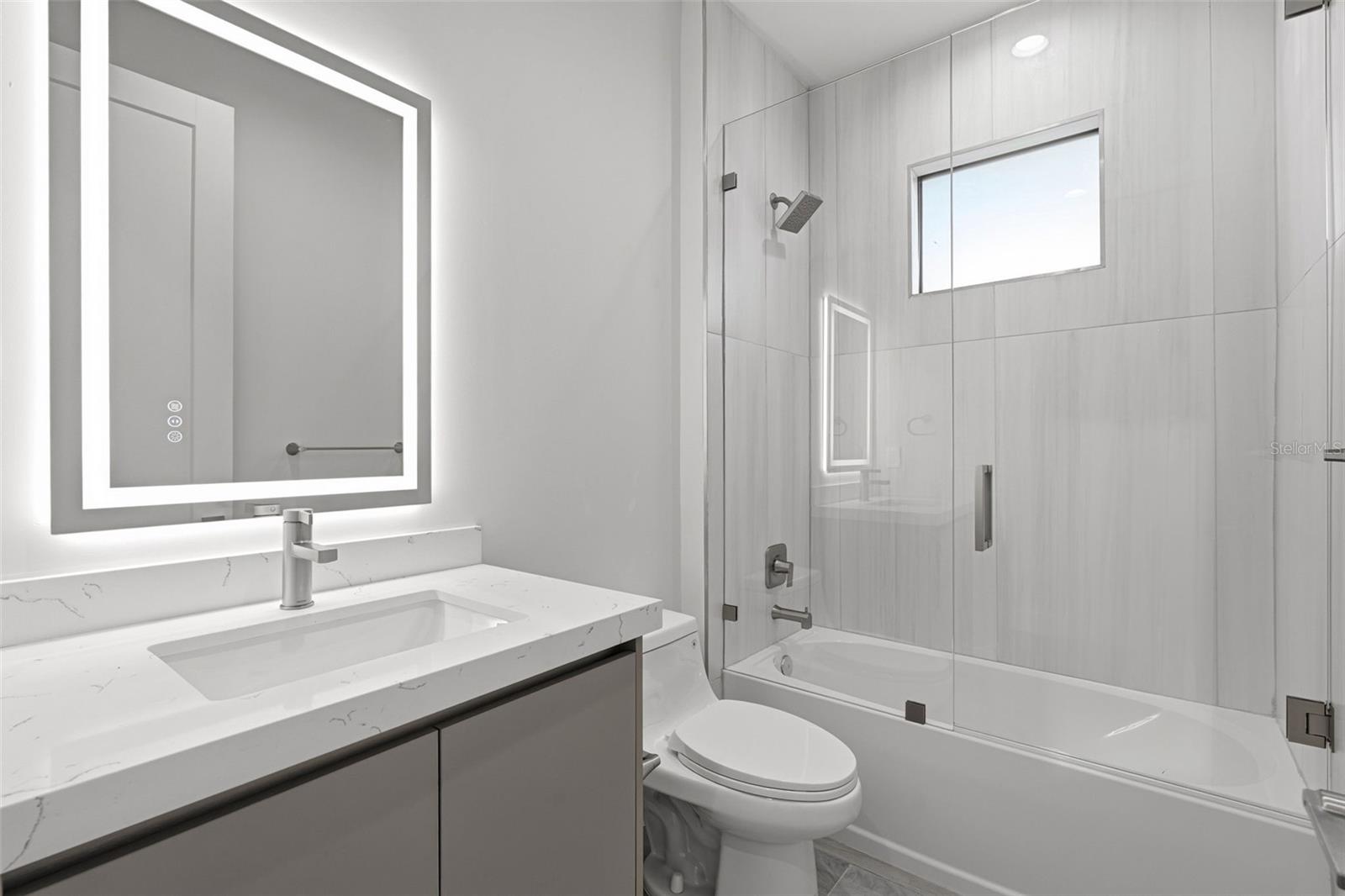 Guest Bathroom with Quartz Vanity and Tub/Shower Combo with Glass Enclosure - 14319 ALLENSWORTH AVE, PORT CHARLOTTE