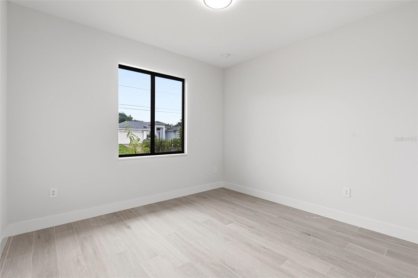 Bedroom 4 Features Natural Light & Porcelain Plank Tile Flooring - 14319 ALLENSWORTH AVE, PORT CHARLOTTE