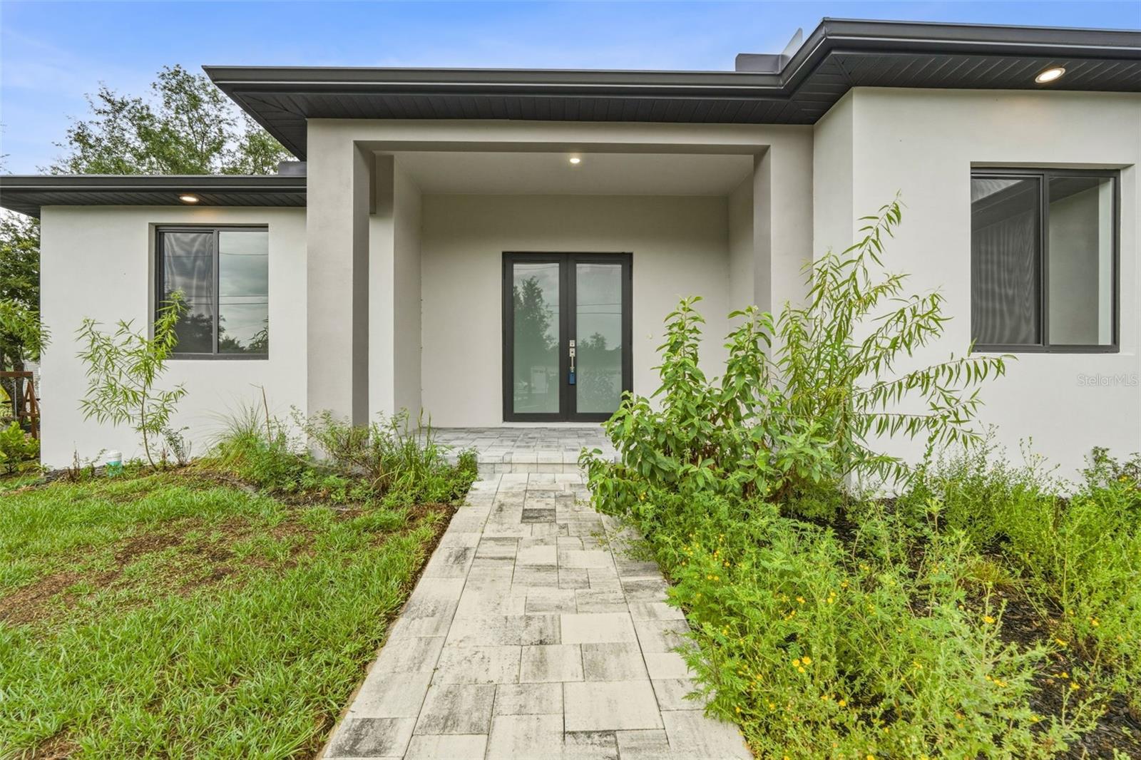 Paver Walkway Leads to Covered Porch and Double Frosted Glass Front Door - 14319 ALLENSWORTH AVE, PORT CHARLOTTE