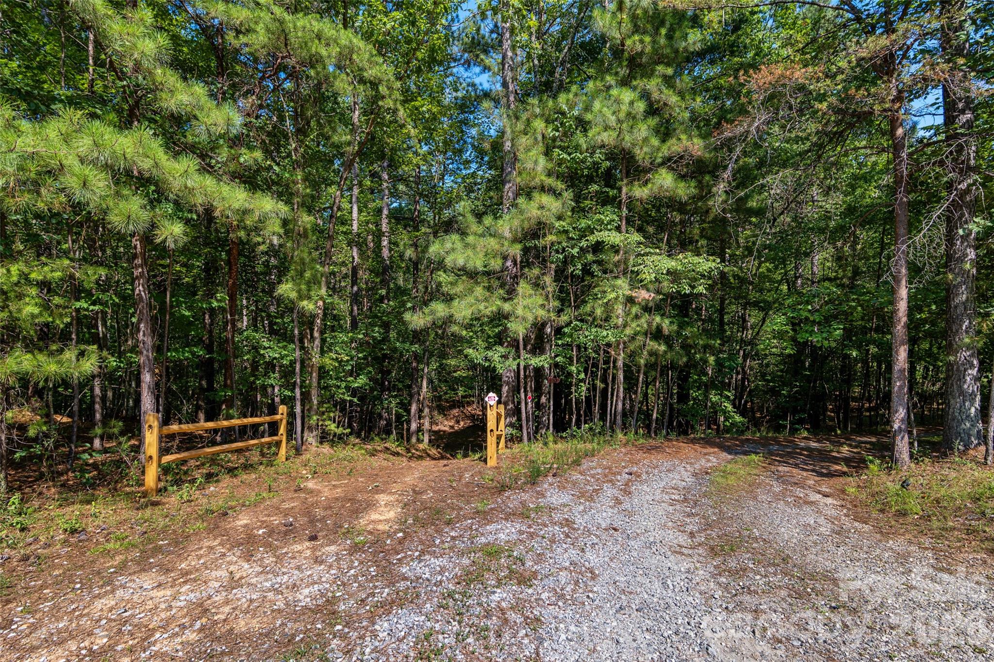 Driveway to the right and Hiking/Equestrian Trail to the right. Lake Adger has over 13 miles of trails throughout the development. Polk County also has FETA equestrian trails within a short driving distance - 4551 Lake Adger Parkway, Mill Spring