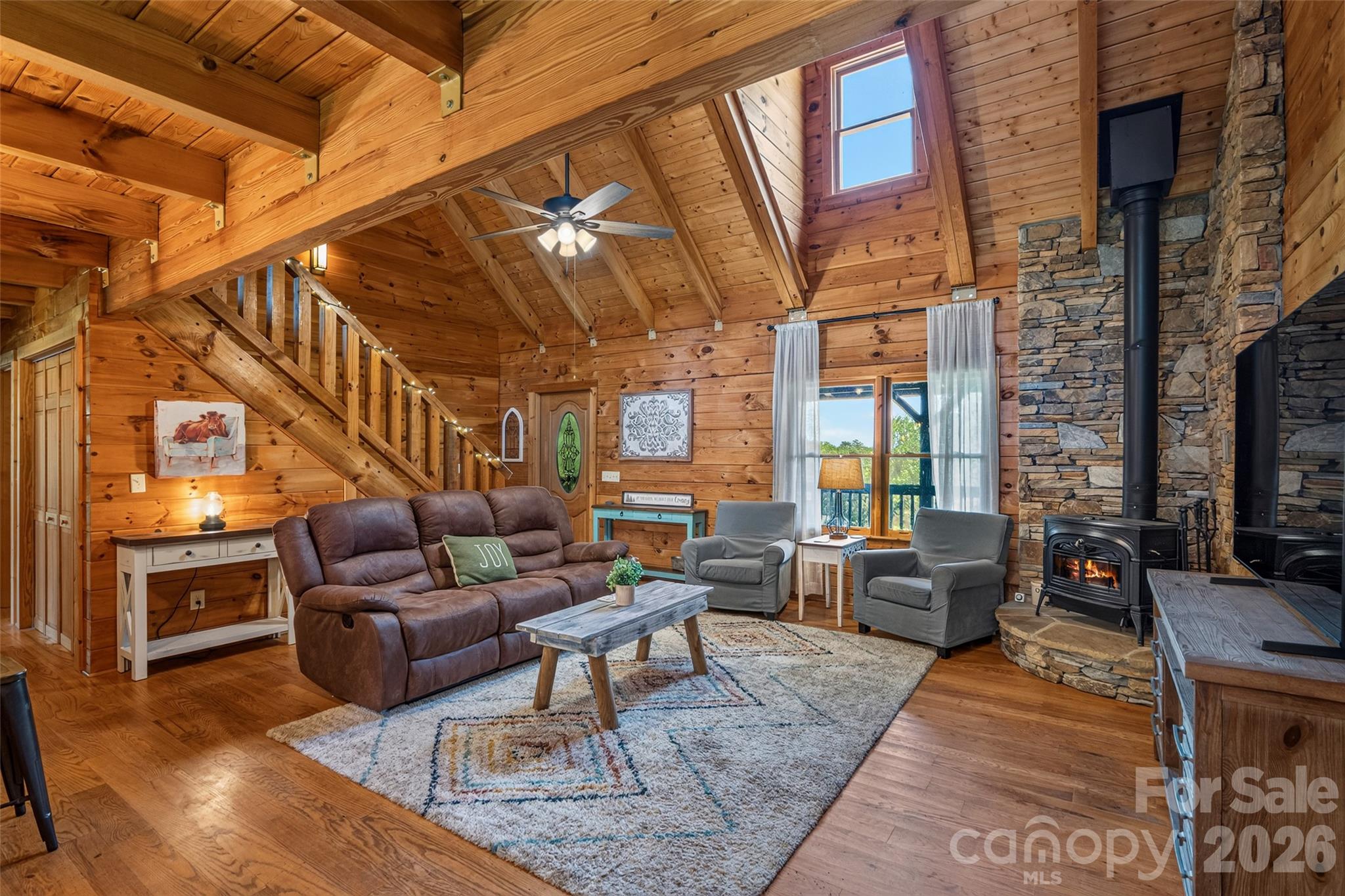 Living Area with Beautiful Rockwork and Encore Wood Stove. - 4551 Lake Adger Parkway, Mill Spring