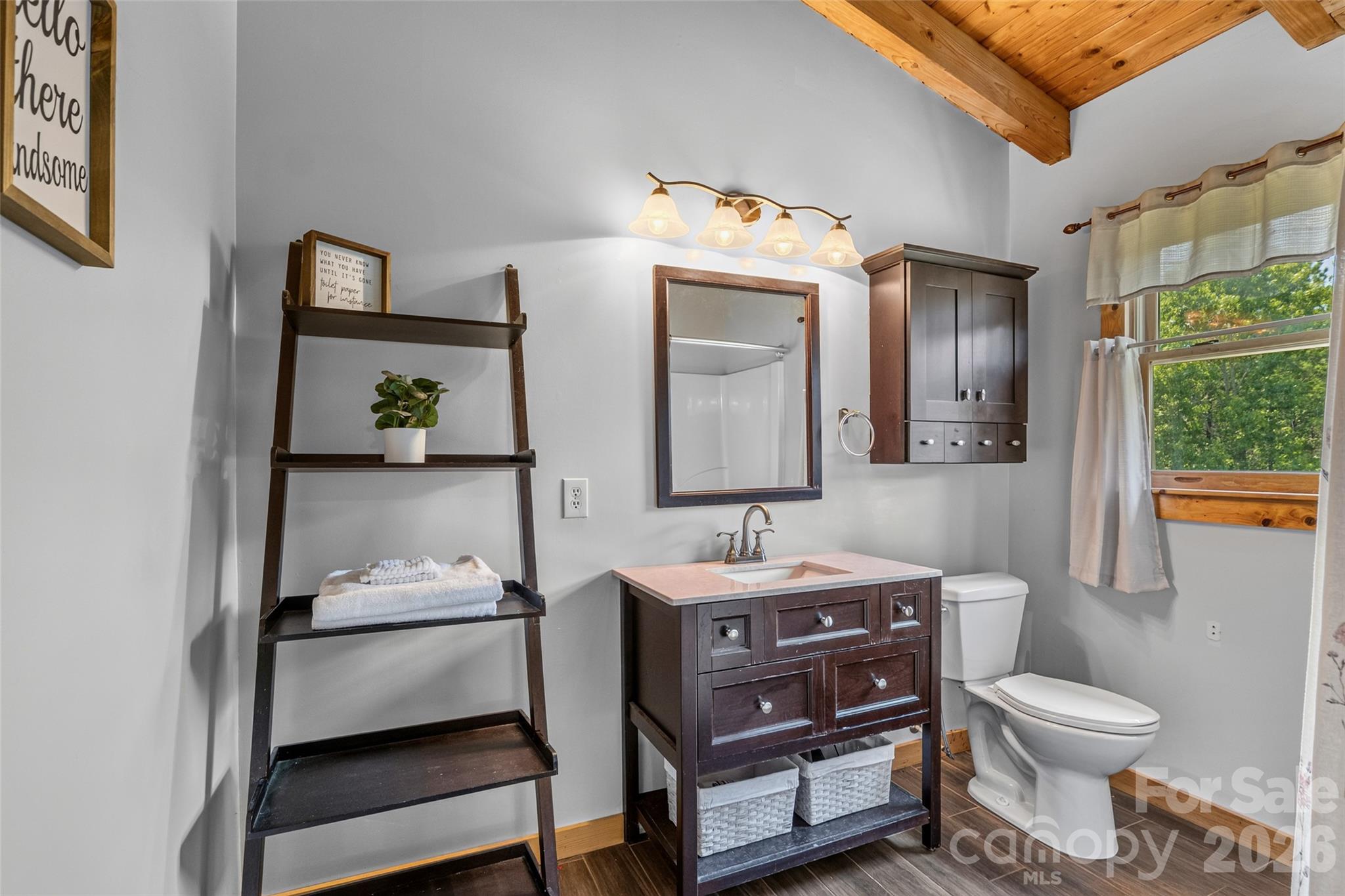 Primary en-suite bath has ceramic floors - 4551 Lake Adger Parkway, Mill Spring