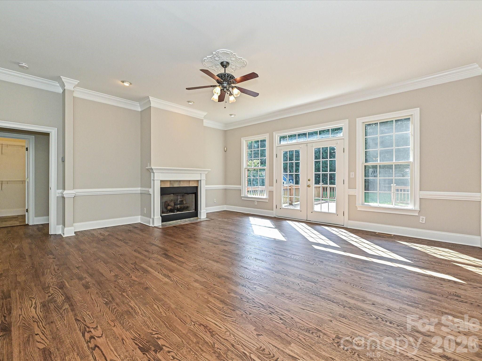 Spacious living room with gas fireplace and French doors to the backyard & deck. - 2354 Perry Road, Denver
