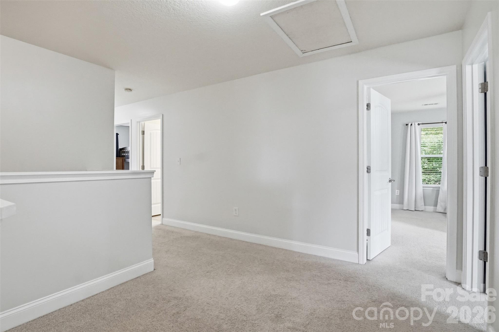 Landing at the top of the stairs with attic access - 835 Estuary Court, Rock Hill