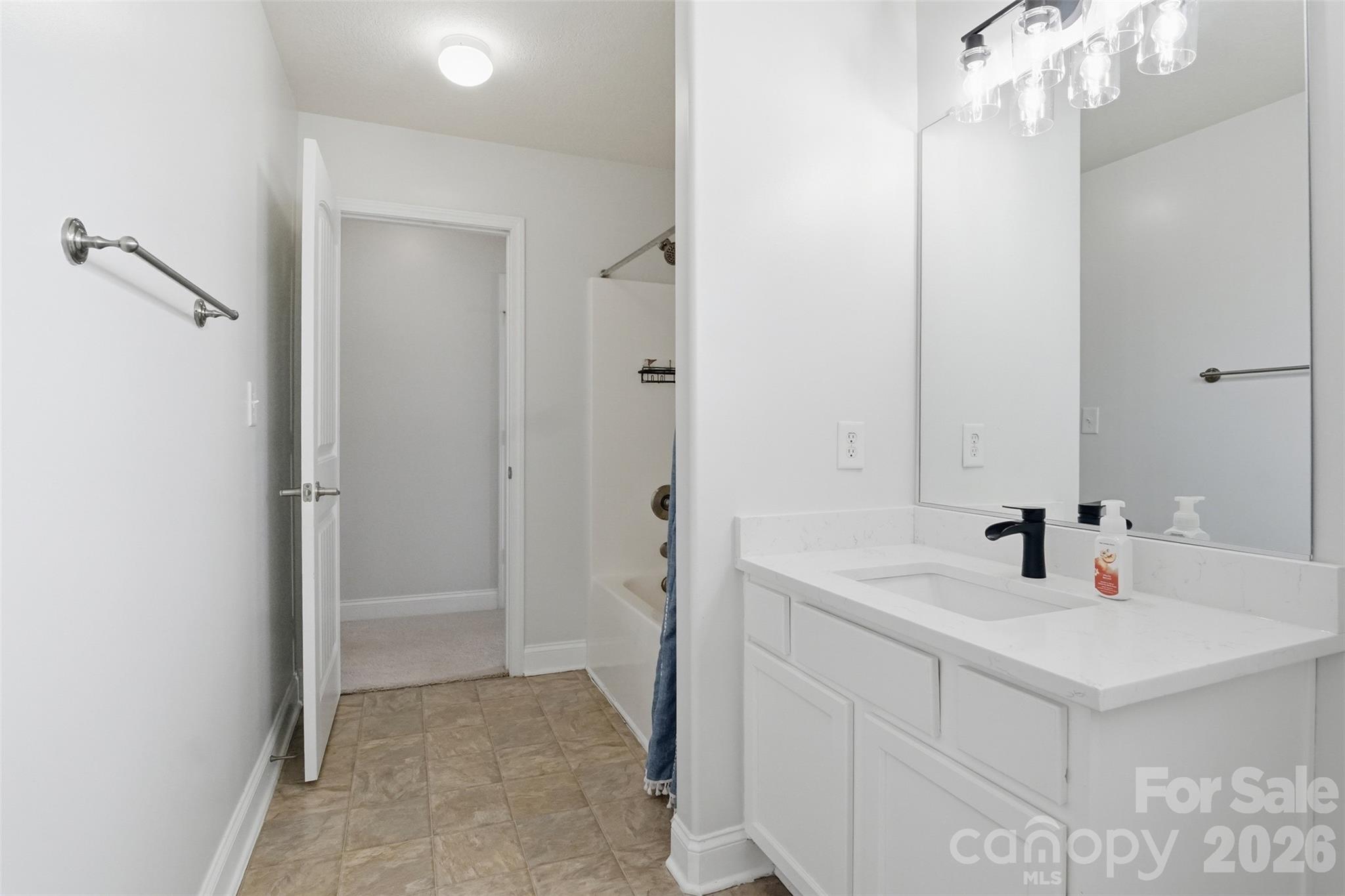 Bathroom with quartz countertop that has access to the hallway and Bedroom #2 - 835 Estuary Court, Rock Hill
