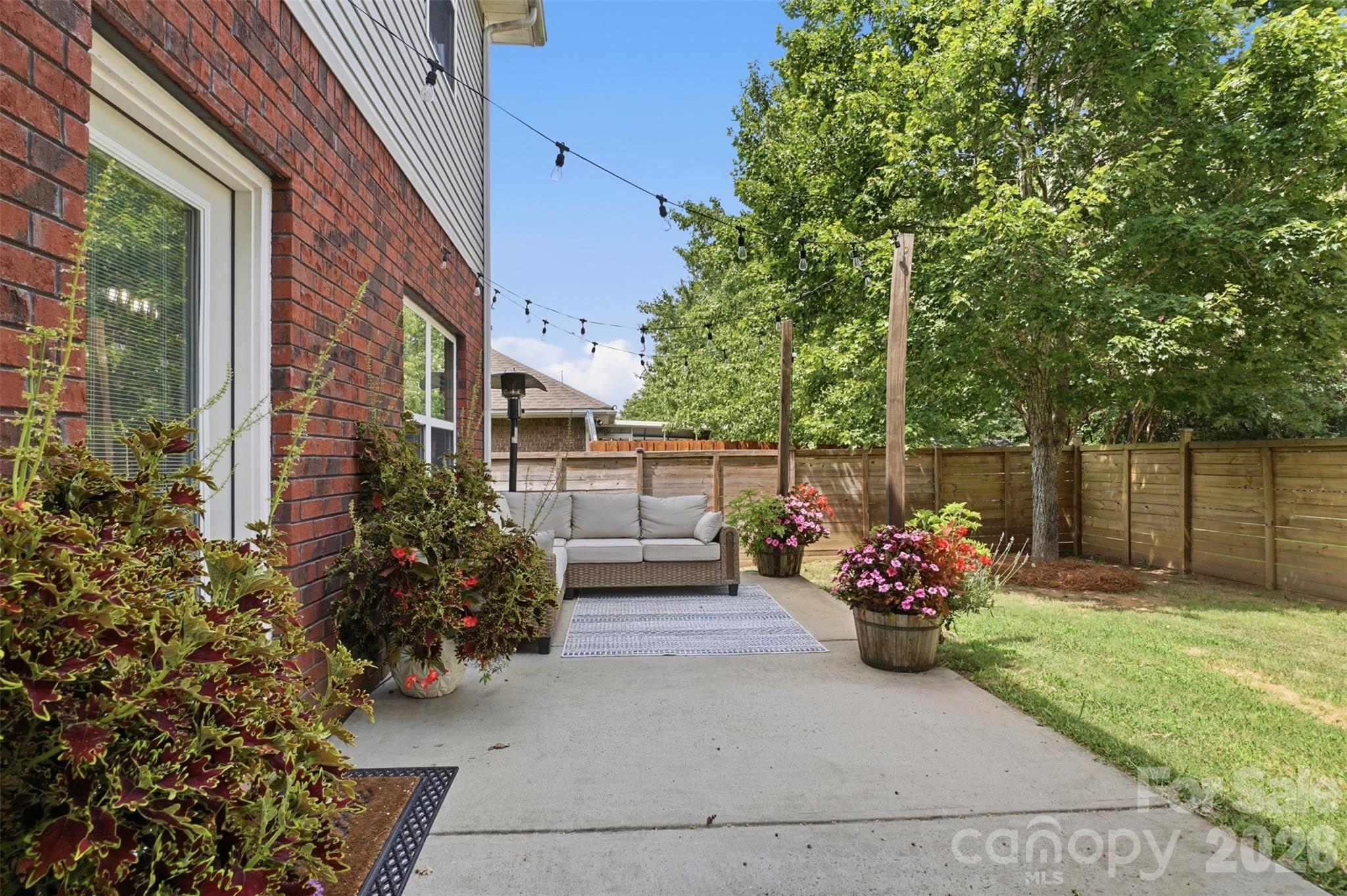 One end of the large patio in the backyard has lots of space to relax! Privacy fencing in the backyard and partial side yards creates an amazing sanctuary! - 835 Estuary Court, Rock Hill