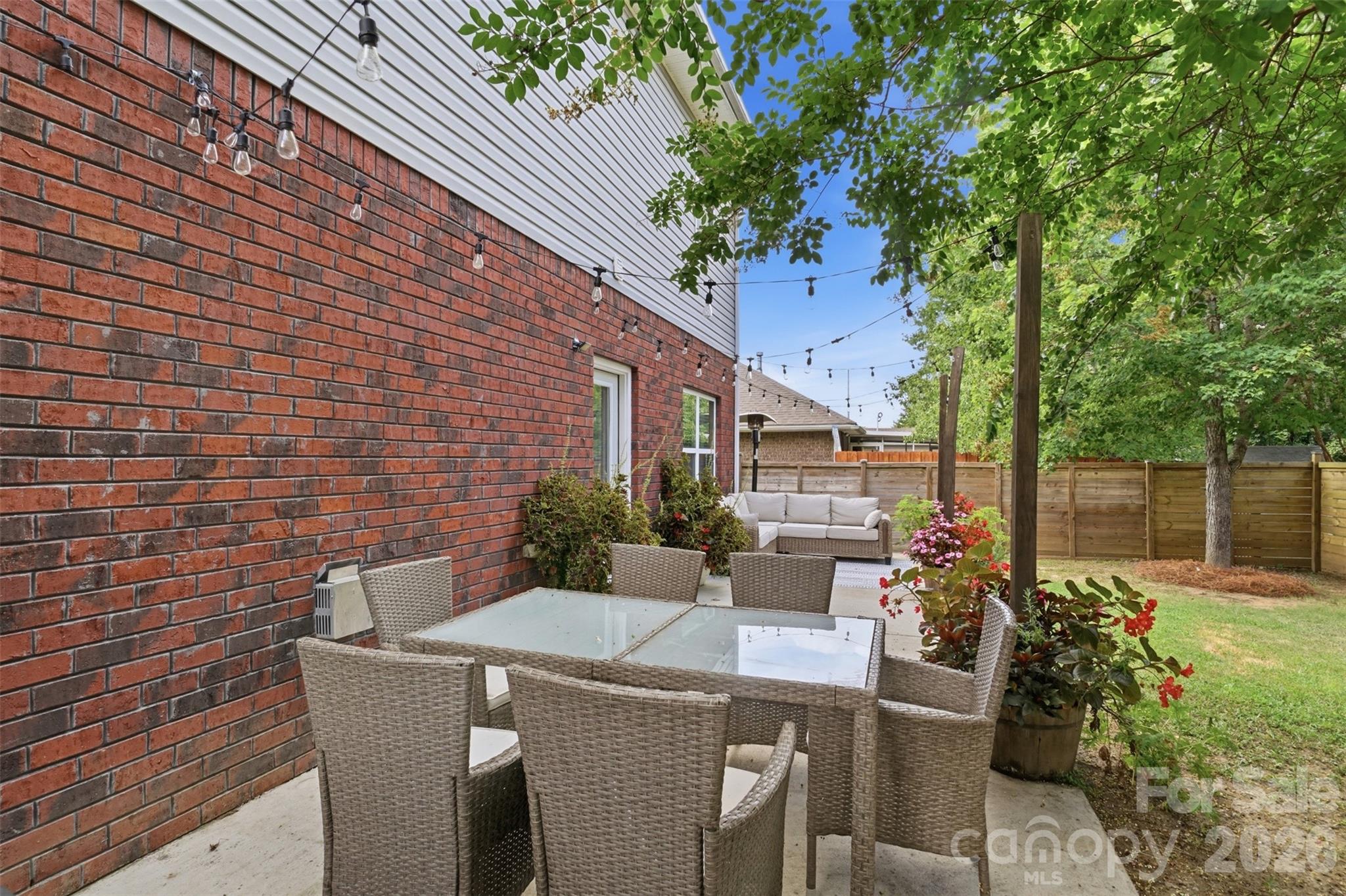 Outdoor eating area with string lights creates an atmosphere of relaxation! - 835 Estuary Court, Rock Hill