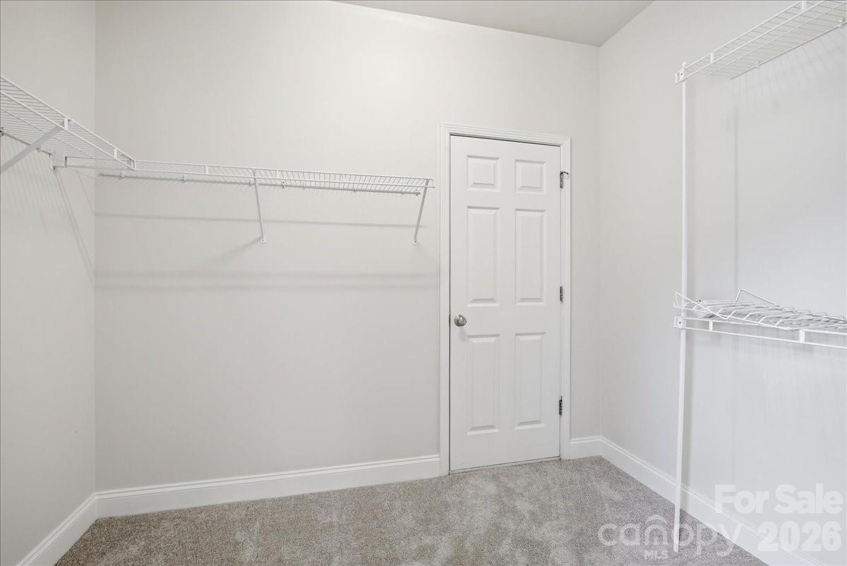 Walk-in closet. Door leads to climate controlled storage/flex space. Can fully finish to expand closet, workout room, office, craft room, etc. - 6055 Latta Springs Circle, Huntersville